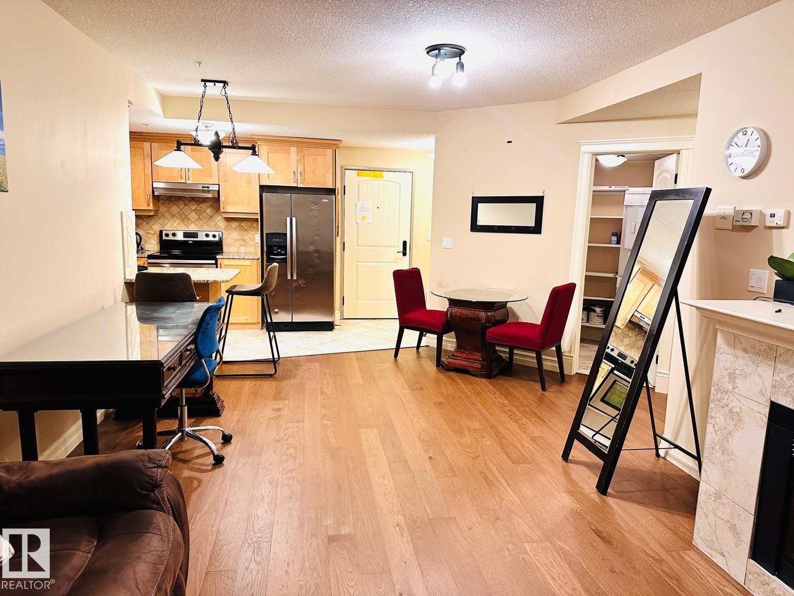 Hardwood-style flooring throughout living areas - #207 10142 111 St Nw, Edmonton, AB - Indoor