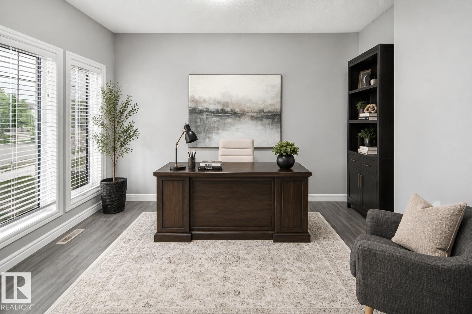Spacious room featuring two large windows, wood-finish flooring, and a built-in bookshelf - 16015 11 Avenue Sw, Edmonton, AB - Indoor Photo Showing Office