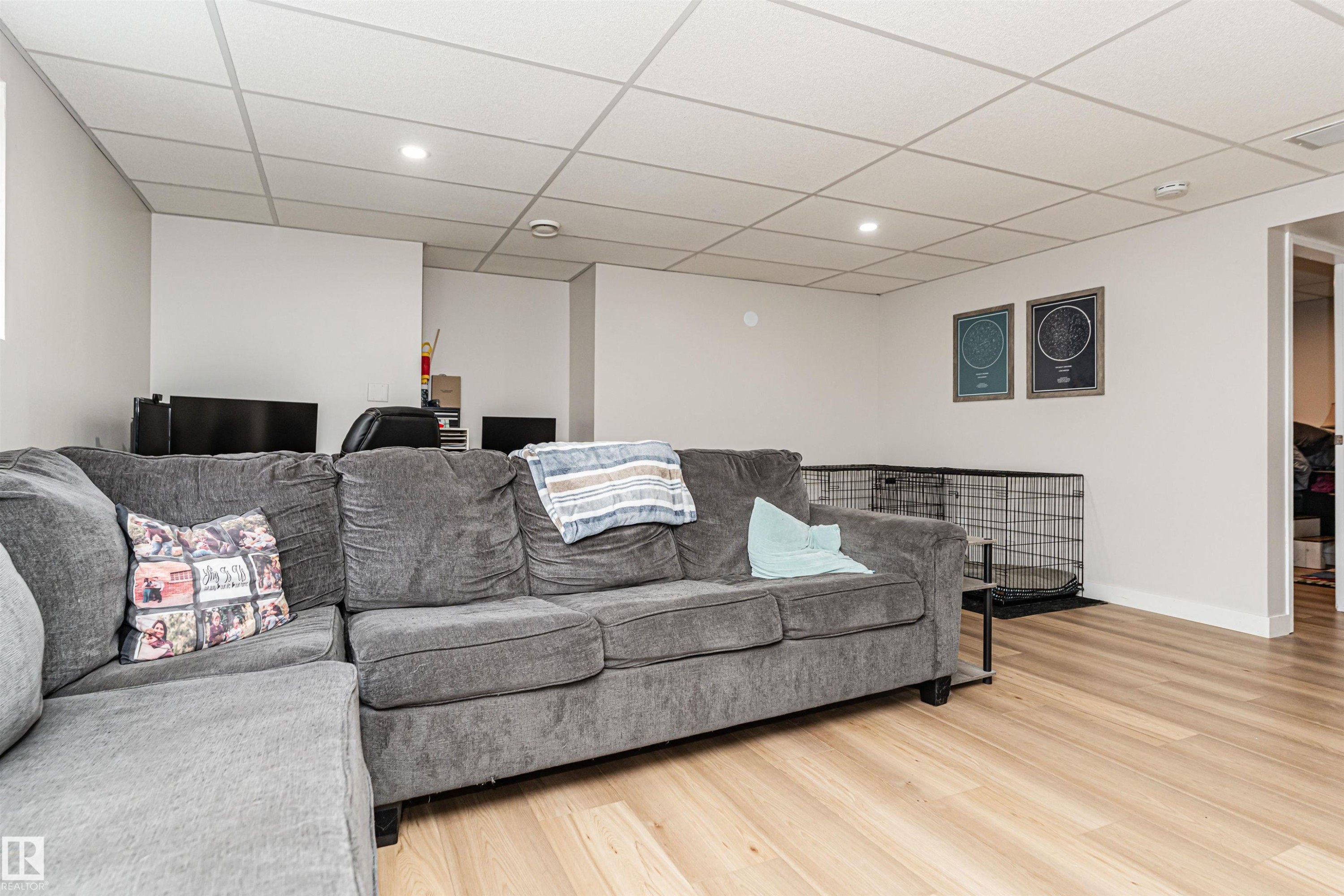 Recessed ceiling lighting, drop ceiling, light wood-finish flooring, white walls, white trim - 4521 29 Avenue Nw, Edmonton, AB - Indoor Photo Showing Living Room