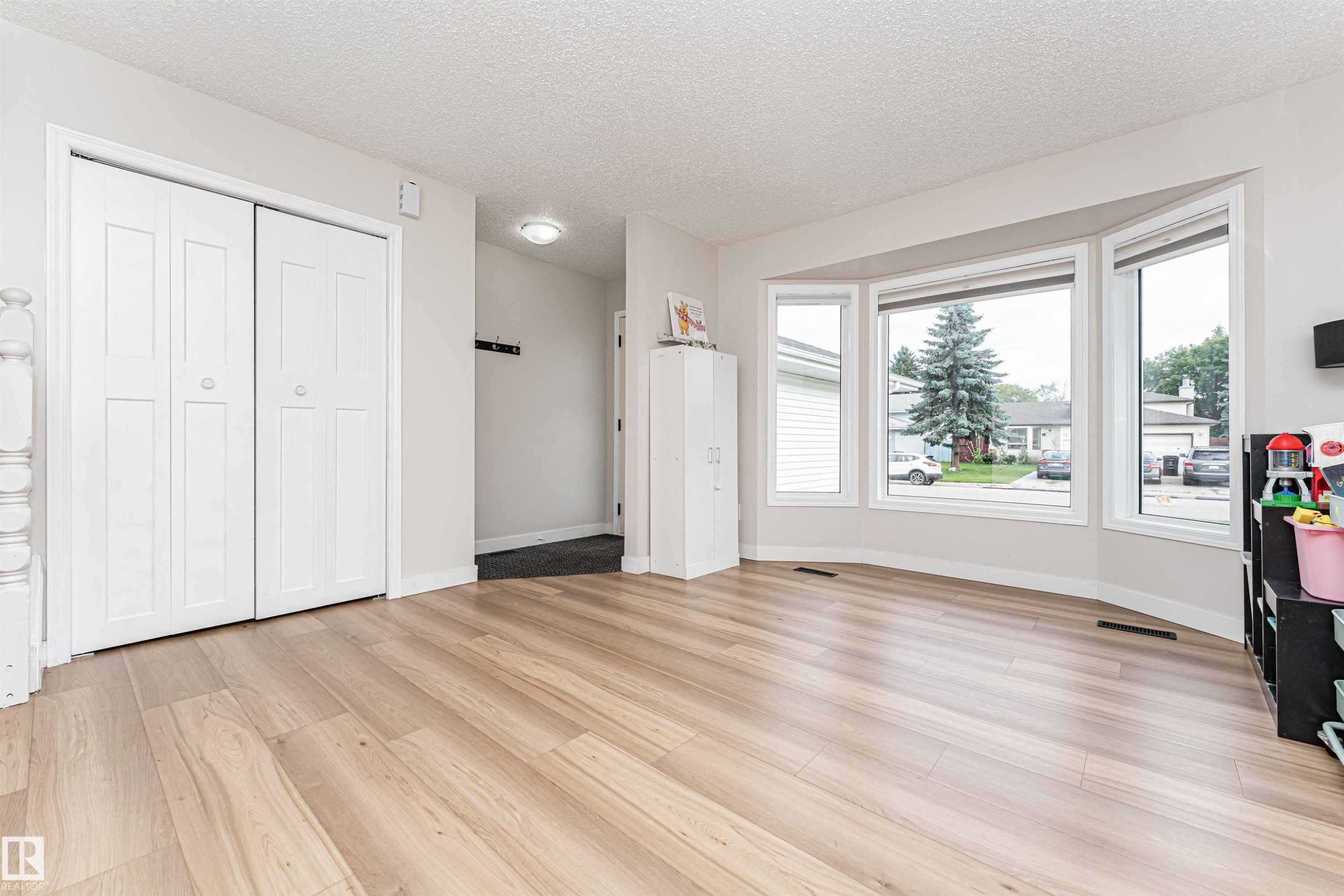Expansive bay window, wood-finish flooring, recessed lighting, and a double bi-fold closet - 4521 29 Avenue Nw, Edmonton, AB - Indoor
