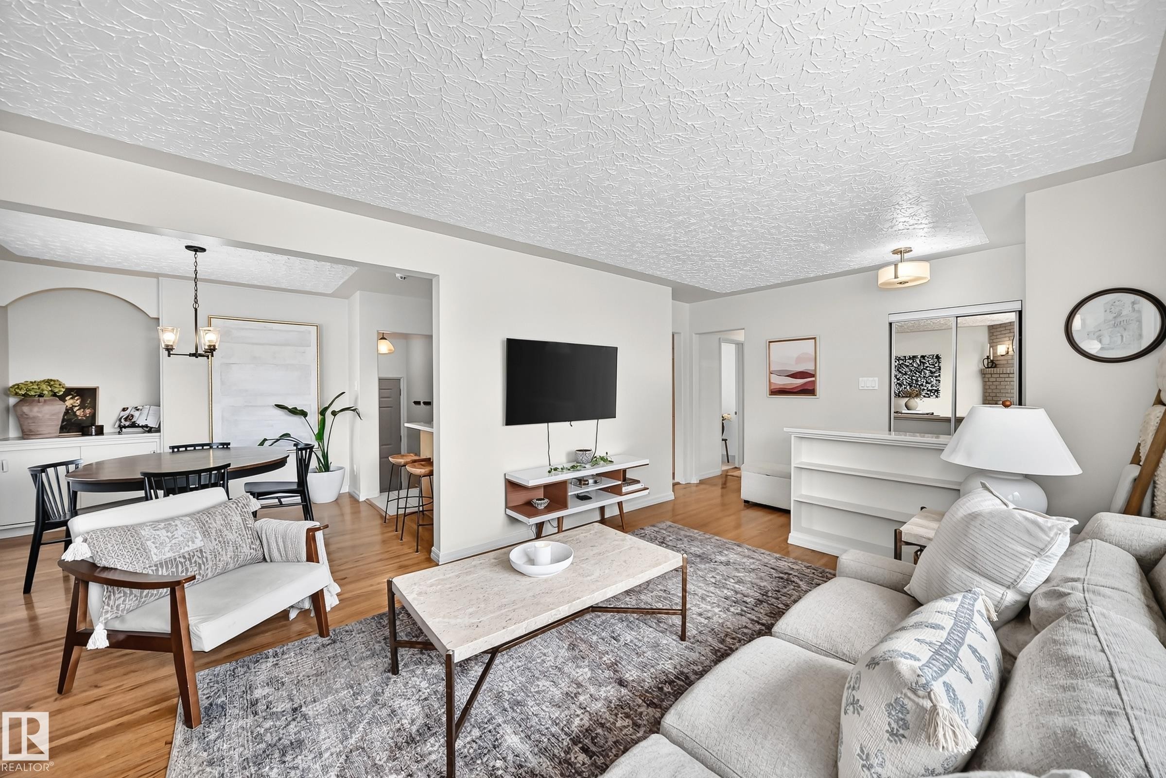 Hardwood flooring, recessed lighting, built-in shelving, and a modern ceiling light fixture - 16406 87A Avenue Nw, Edmonton, AB - Indoor Photo Showing Living Room