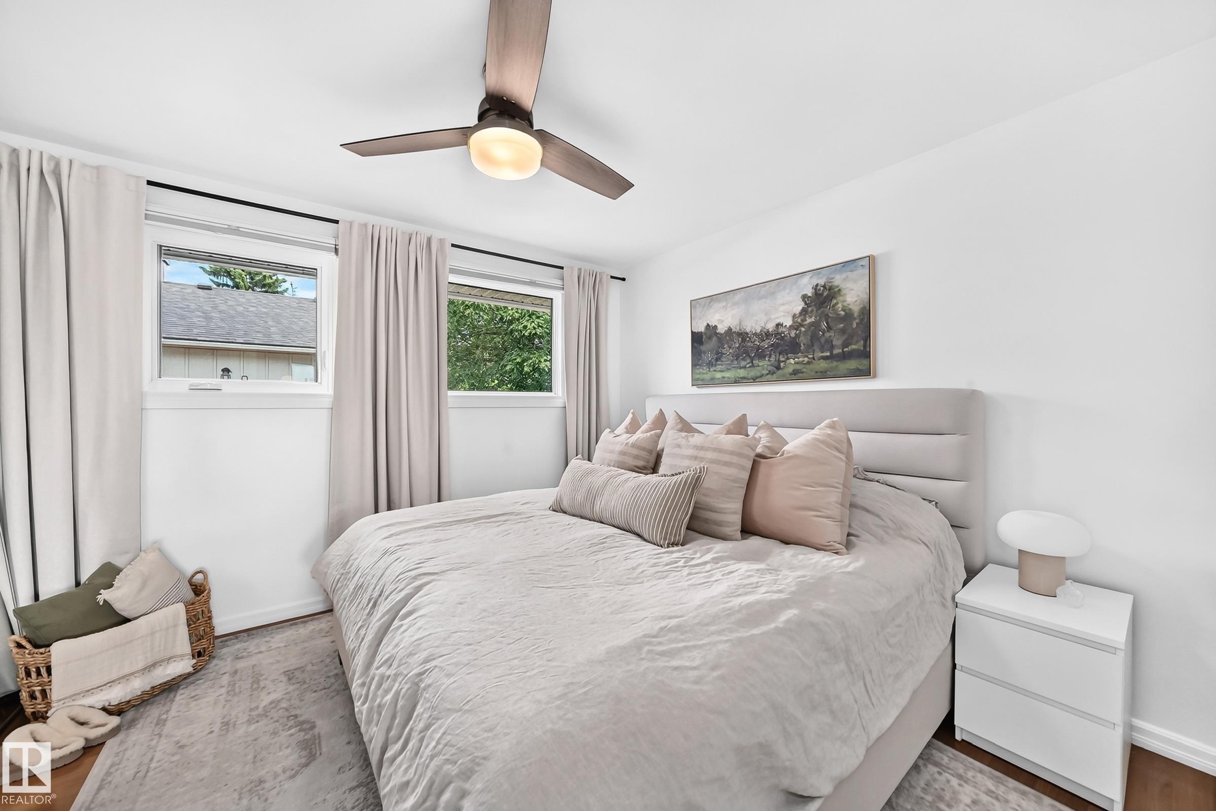 Recessed lighting, wood-finish flooring, two large windows, white walls, and a ceiling fan with integrated lighting - 16406 87A Avenue Nw, Edmonton, AB - Indoor Photo Showing Bedroom