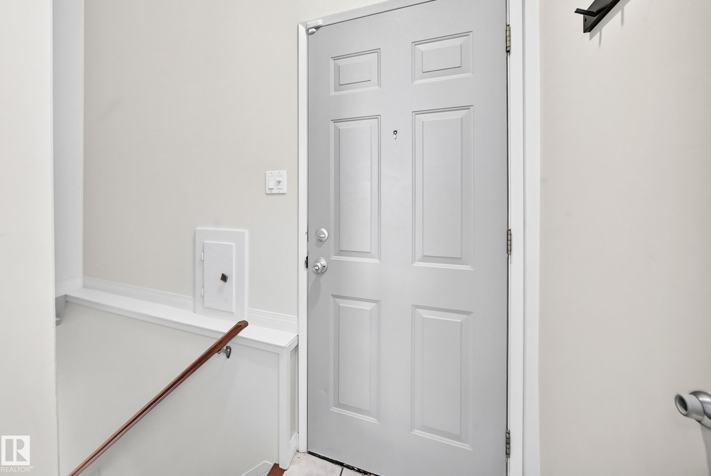 Panel-style entry door with chrome hardware - 16406 87A Avenue Nw, Edmonton, AB - Indoor Photo Showing Other Room