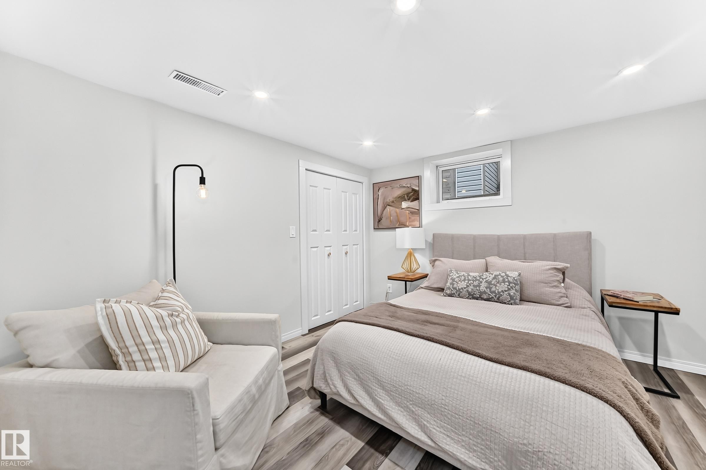 Recessed ceiling lighting, wood-finish flooring, and a window with a window-mounted unit - 16406 87A Avenue Nw, Edmonton, AB - Indoor Photo Showing Bedroom