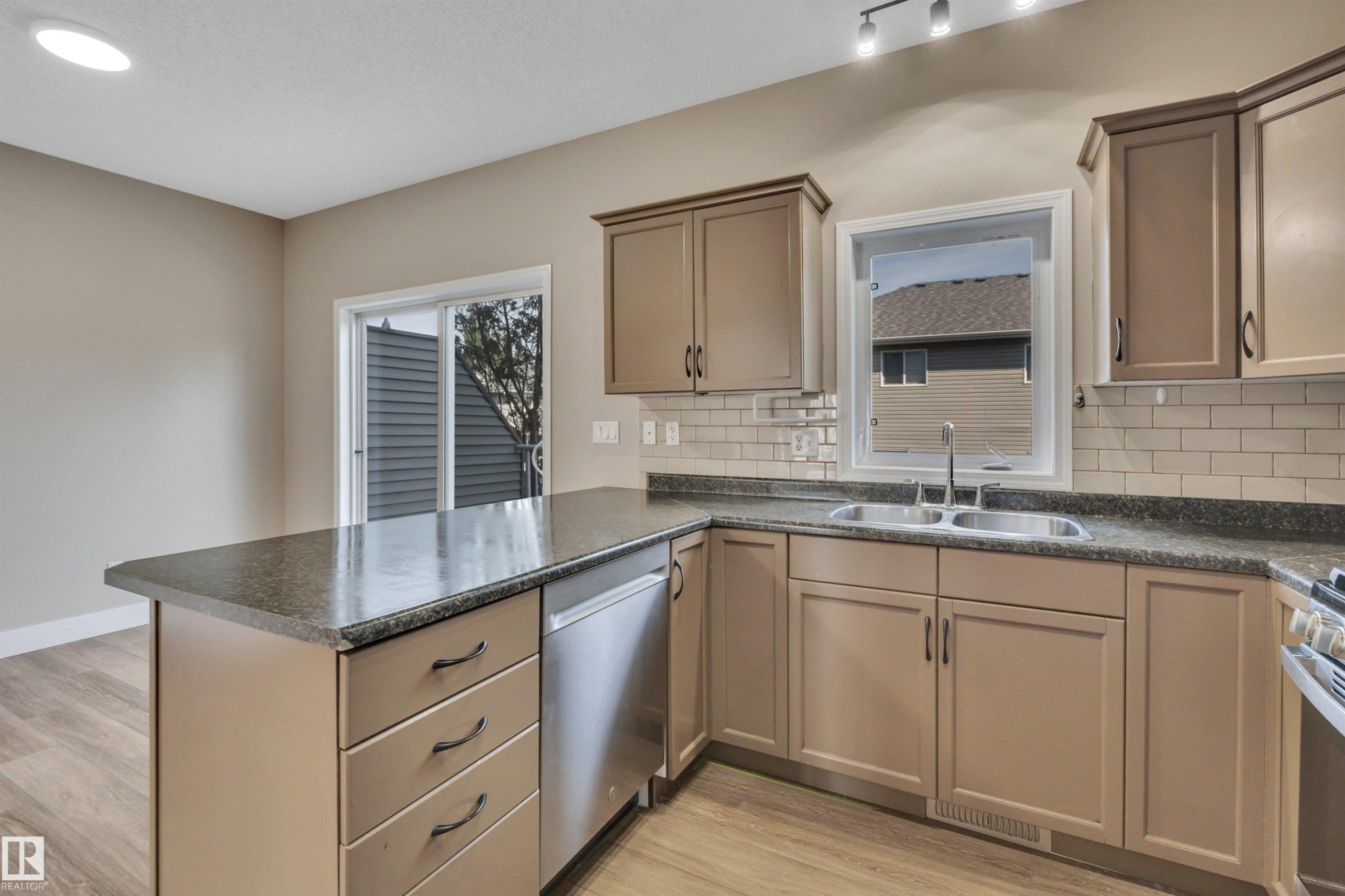 #23 5102 30 Av, Beaumont, AB - Indoor Photo Showing Kitchen With Double Sink