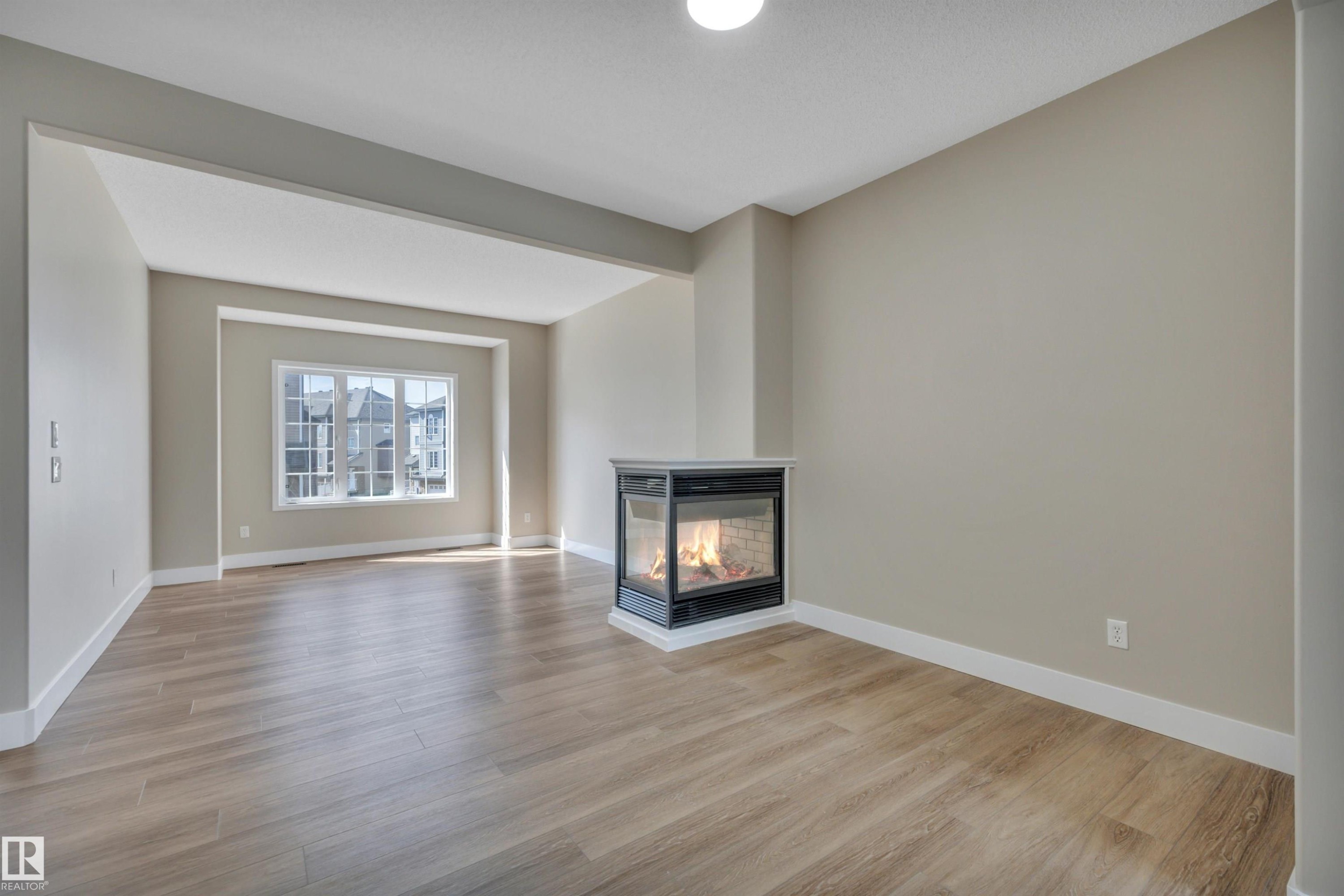 #23 5102 30 Av, Beaumont, AB - Indoor Photo Showing Living Room With Fireplace