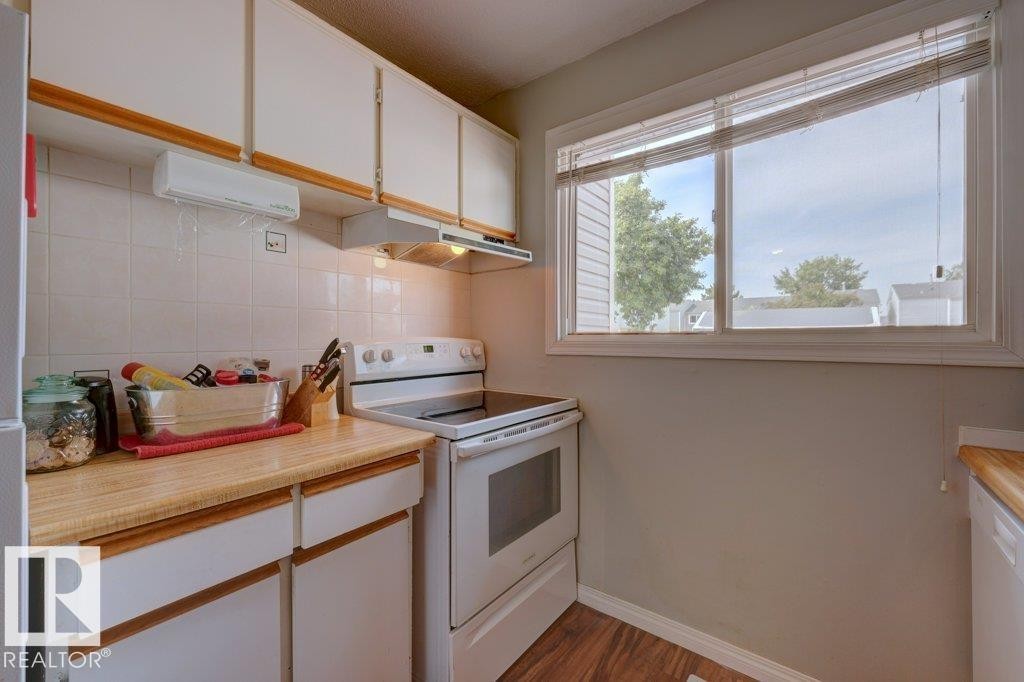 White cabinetry with wood-finish handles and laminate countertops - 307 Northgate Terrace Nw, Edmonton, AB - Indoor Photo Showing Kitchen