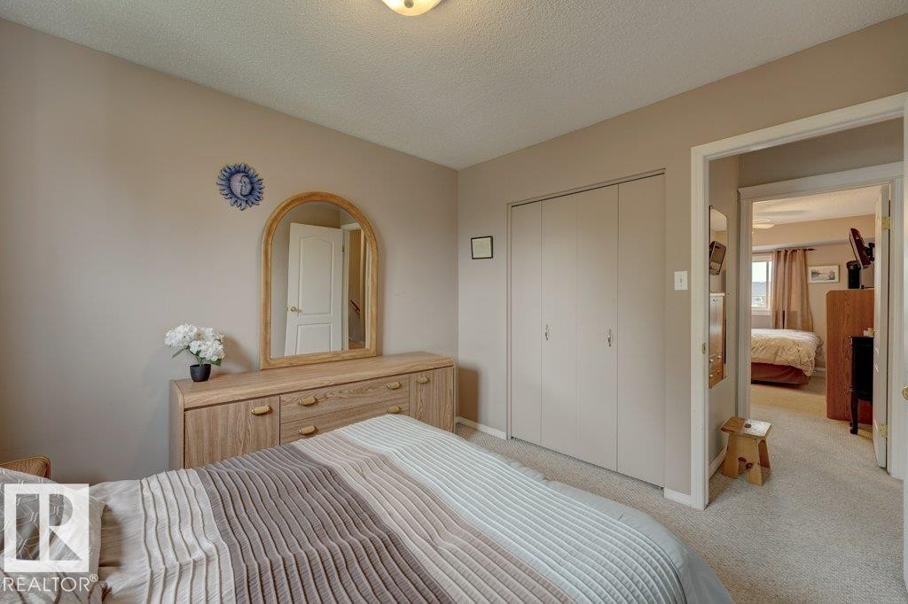 Neutral wall tones, carpeted flooring, and a flush mount ceiling light fixture - 307 Northgate Terrace Nw, Edmonton, AB - Indoor Photo Showing Bedroom