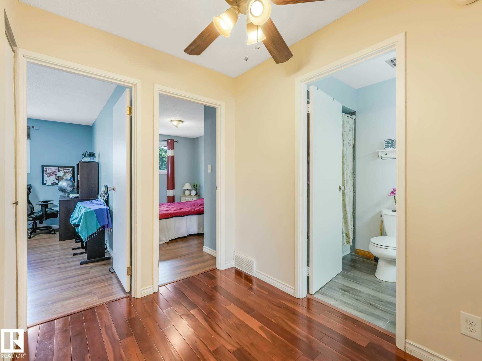Wood-finish flooring throughout the hallway - 13405 40 St Nw, Edmonton, AB - Indoor