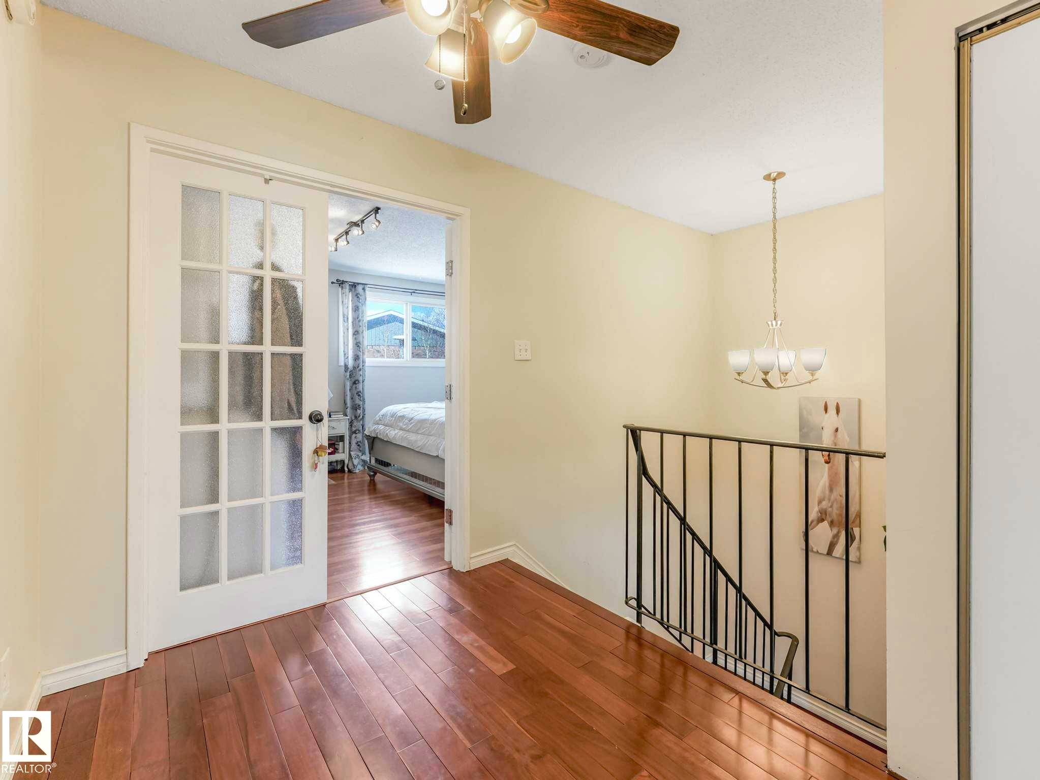 Hardwood-style flooring throughout - 13405 40 St Nw, Edmonton, AB - Indoor Photo Showing Other Room