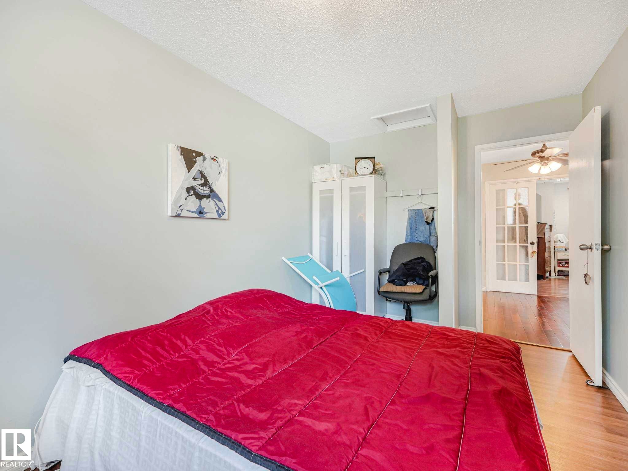 Bedroom featuring wood-finish flooring, light-colored walls, and a white ceiling - 13405 40 St Nw, Edmonton, AB - Indoor Photo Showing Bedroom