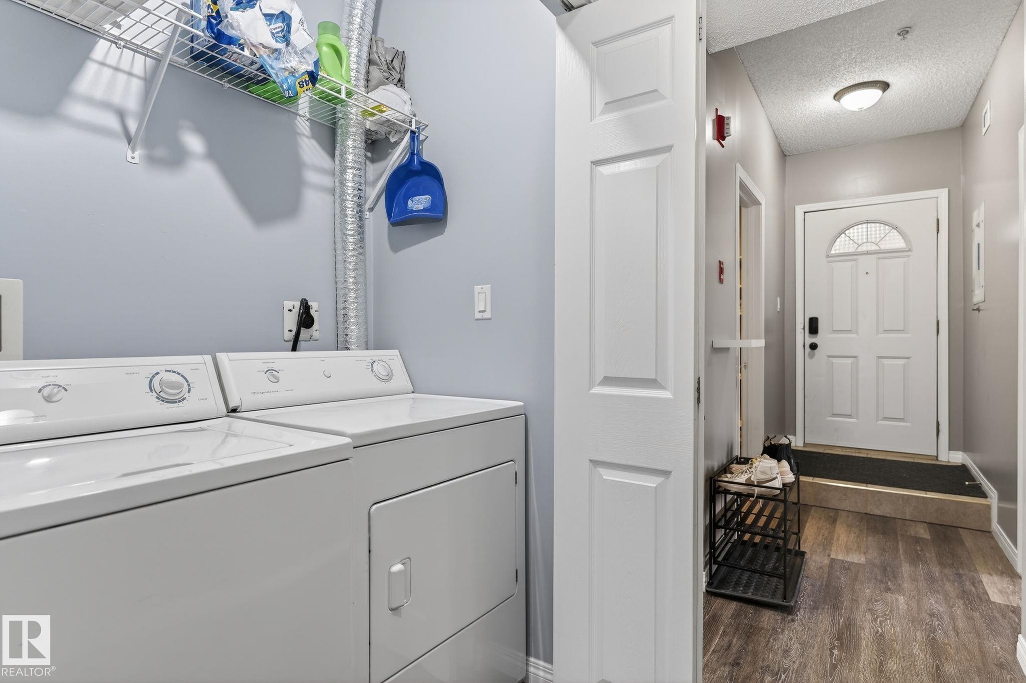 Dedicated laundry area with washer and dryer, complemented by wire shelving - #103 8108 109 St Nw, Edmonton, AB - Indoor Photo Showing Laundry Room