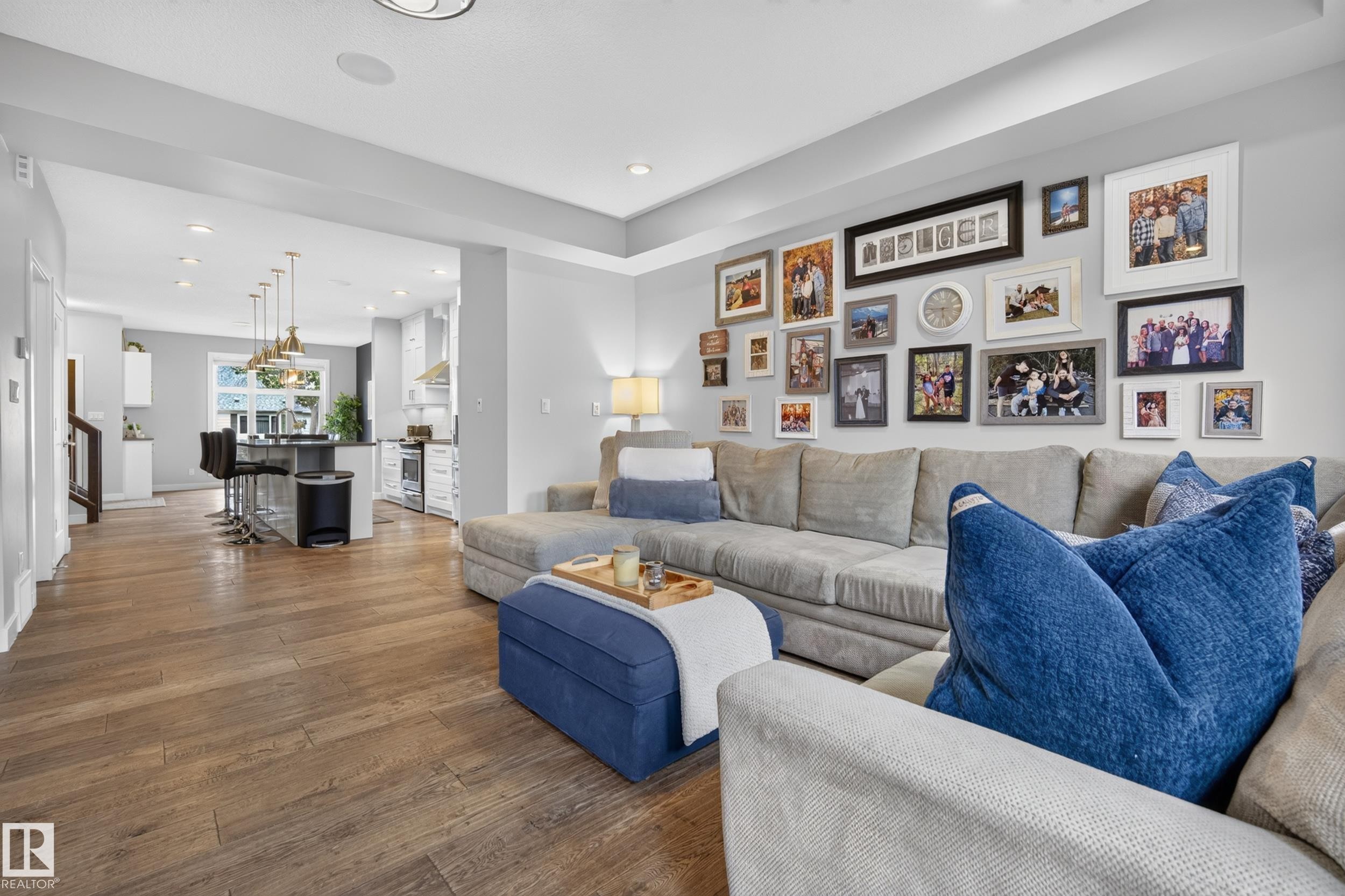 Open-concept living area with wood-finish flooring, recessed lighting, and a tray ceiling - 11018 122 Street Nw, Edmonton, AB - Indoor Photo Showing Living Room