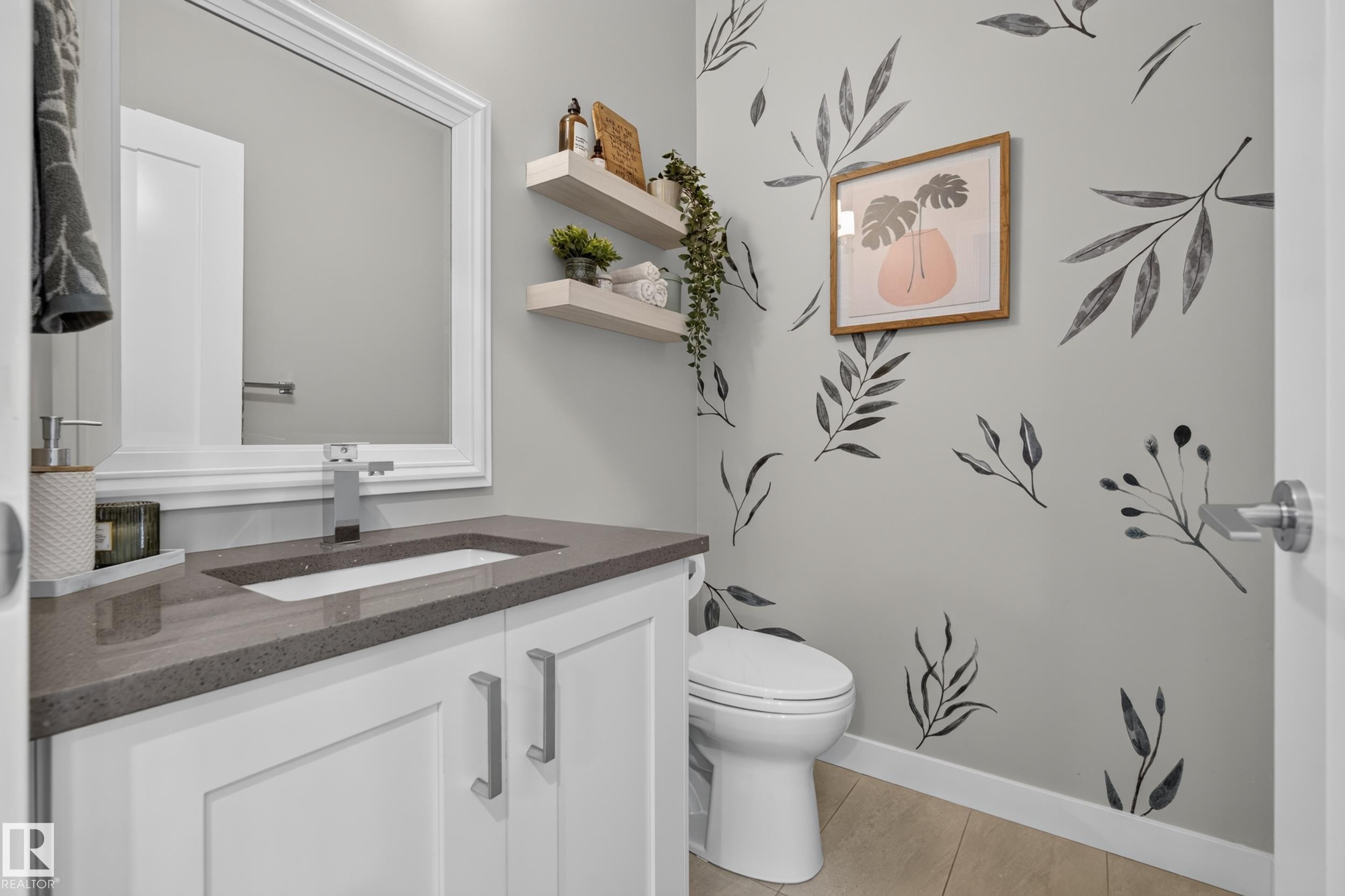 White vanity with brushed nickel hardware, integrated rectangular sink, gray countertop, and wood-finish flooring - 11018 122 Street Nw, Edmonton, AB - Indoor Photo Showing Bathroom