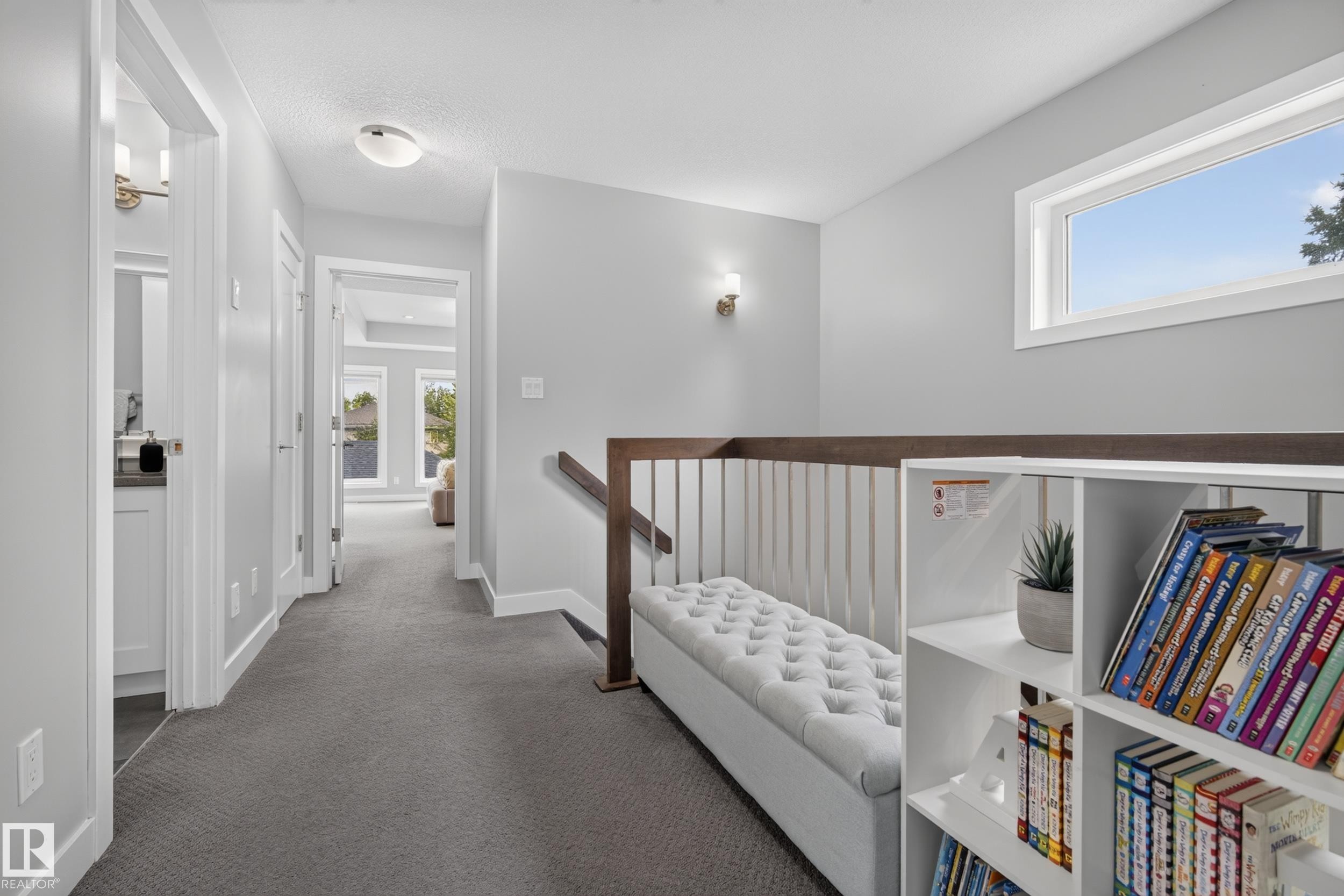 Carpeted hallway with a built-in bench, open shelving, and a prominent window - 11018 122 Street Nw, Edmonton, AB - Indoor Photo Showing Other Room