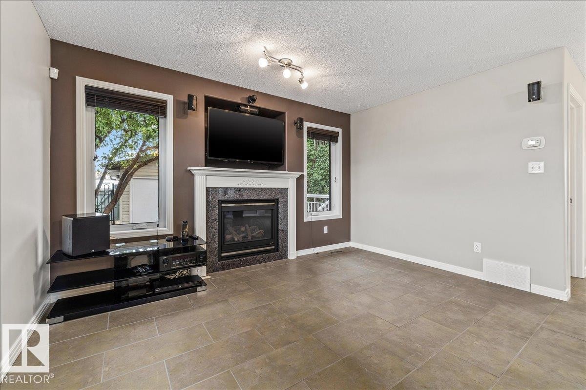 Living room - 1086 Grantham Drive Nw, Edmonton, AB - Indoor Photo Showing Living Room With Fireplace