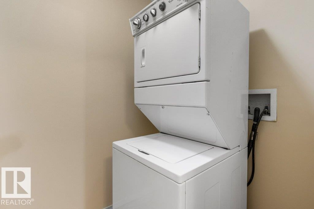 Stackable washer and dryer unit - #307 1188 Hyndman Rd Nw, Edmonton, AB - Indoor Photo Showing Laundry Room