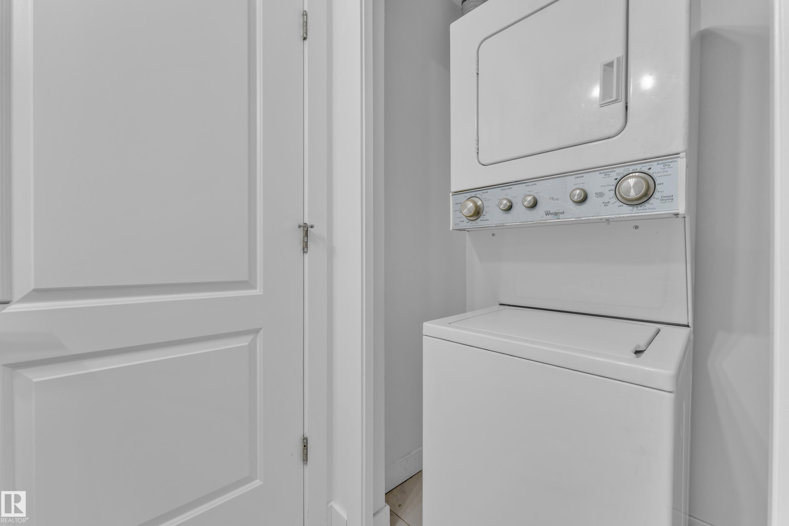 Stackable laundry unit - #217 667 Watt Bv Sw, Edmonton, AB - Indoor Photo Showing Laundry Room