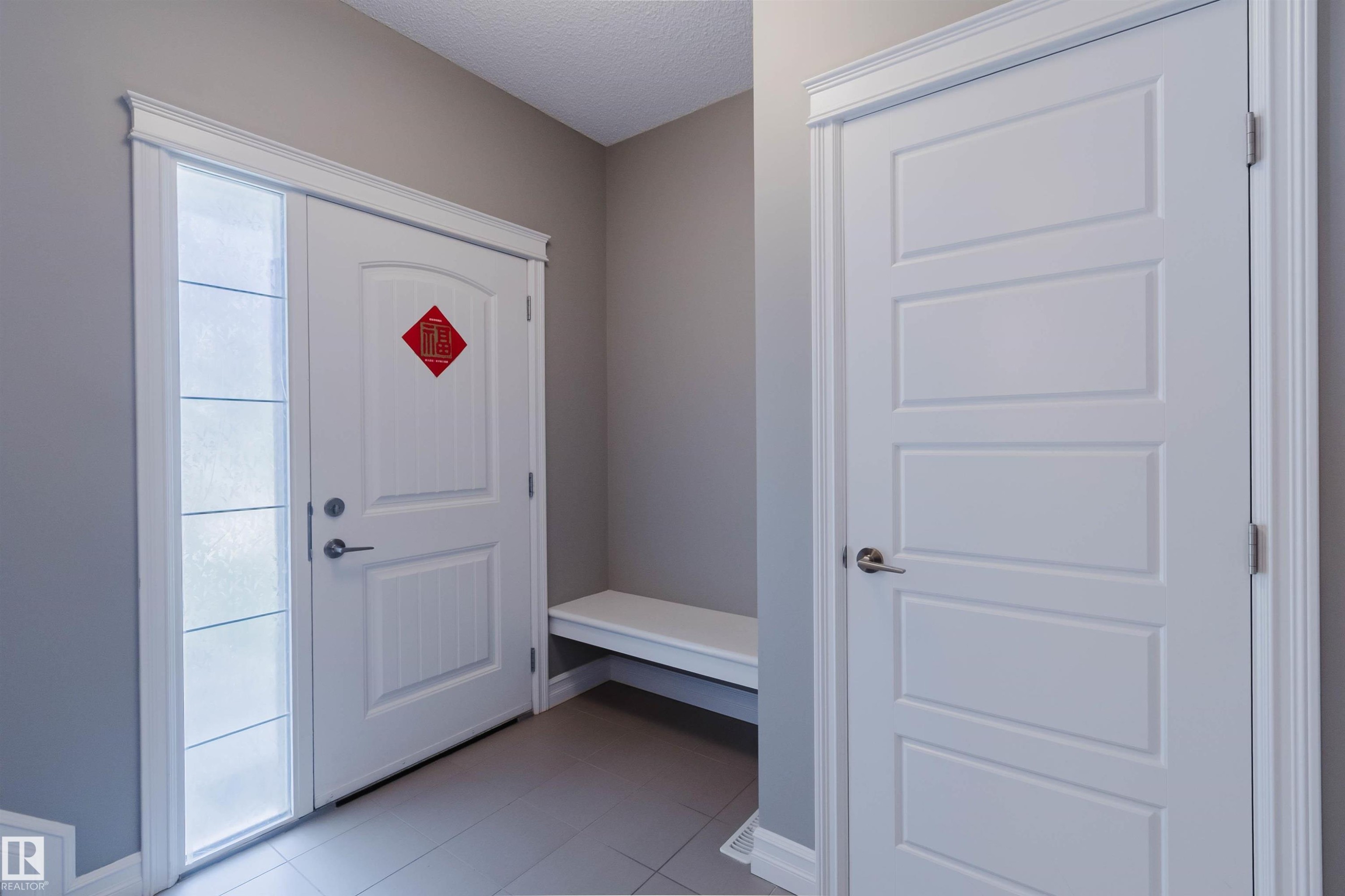 Entryway featuring a paneled door with frosted sidelight, white trim, and light gray wall paint - 15839 10 Avenue Sw, Edmonton, AB - Indoor Photo Showing Other Room