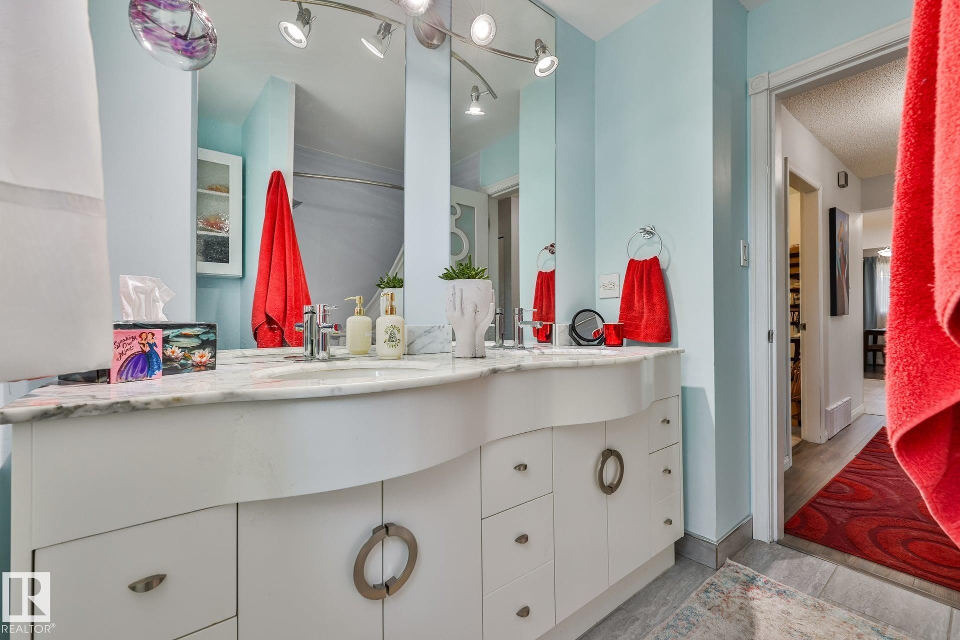 Dual vanity with a stone countertop, individual mirrors, and track lighting - 8932 187 Street Nw, Edmonton, AB - Indoor Photo Showing Bathroom