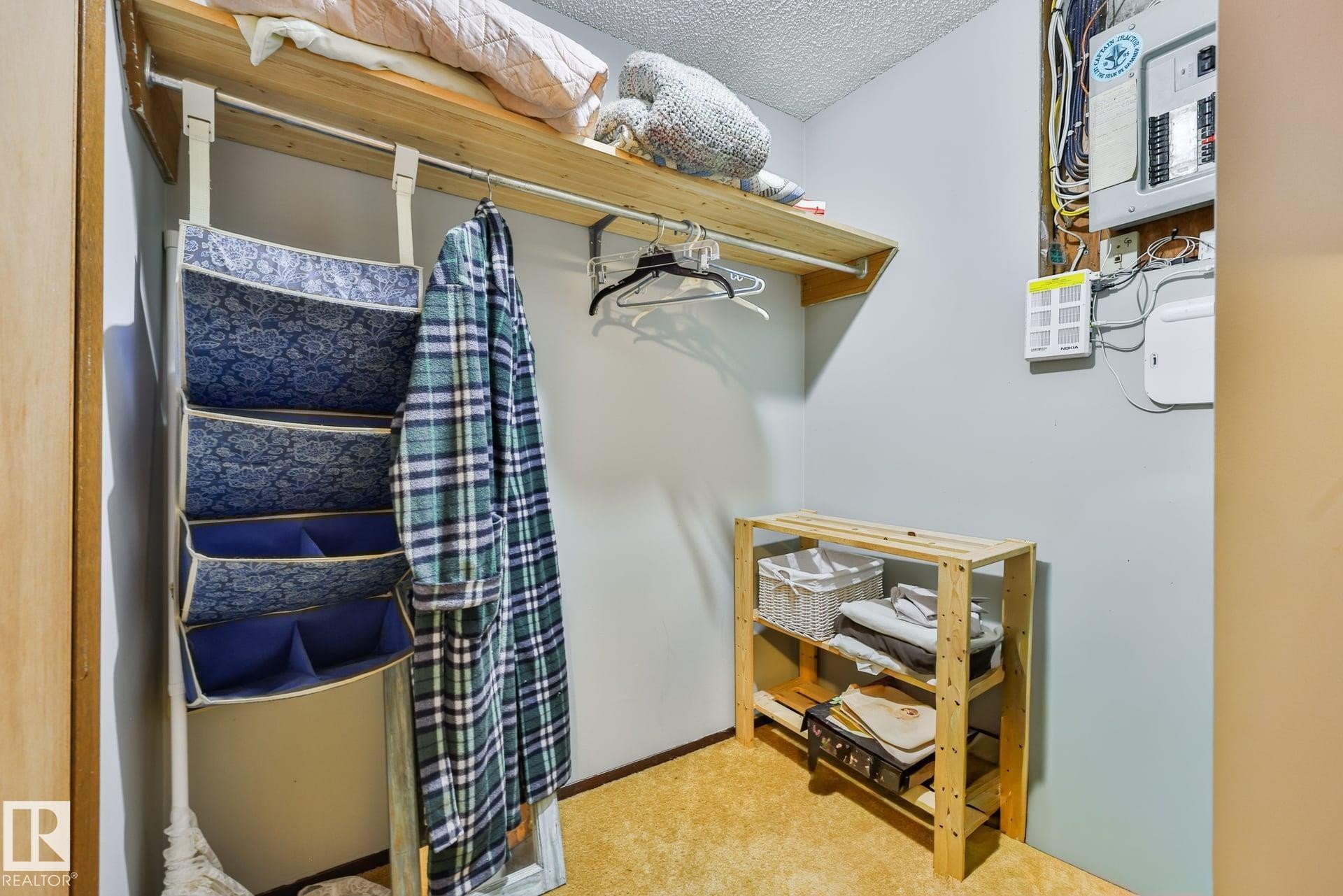 Built-in overhead shelving with a hanging rod - 8932 187 Street Nw, Edmonton, AB - Indoor