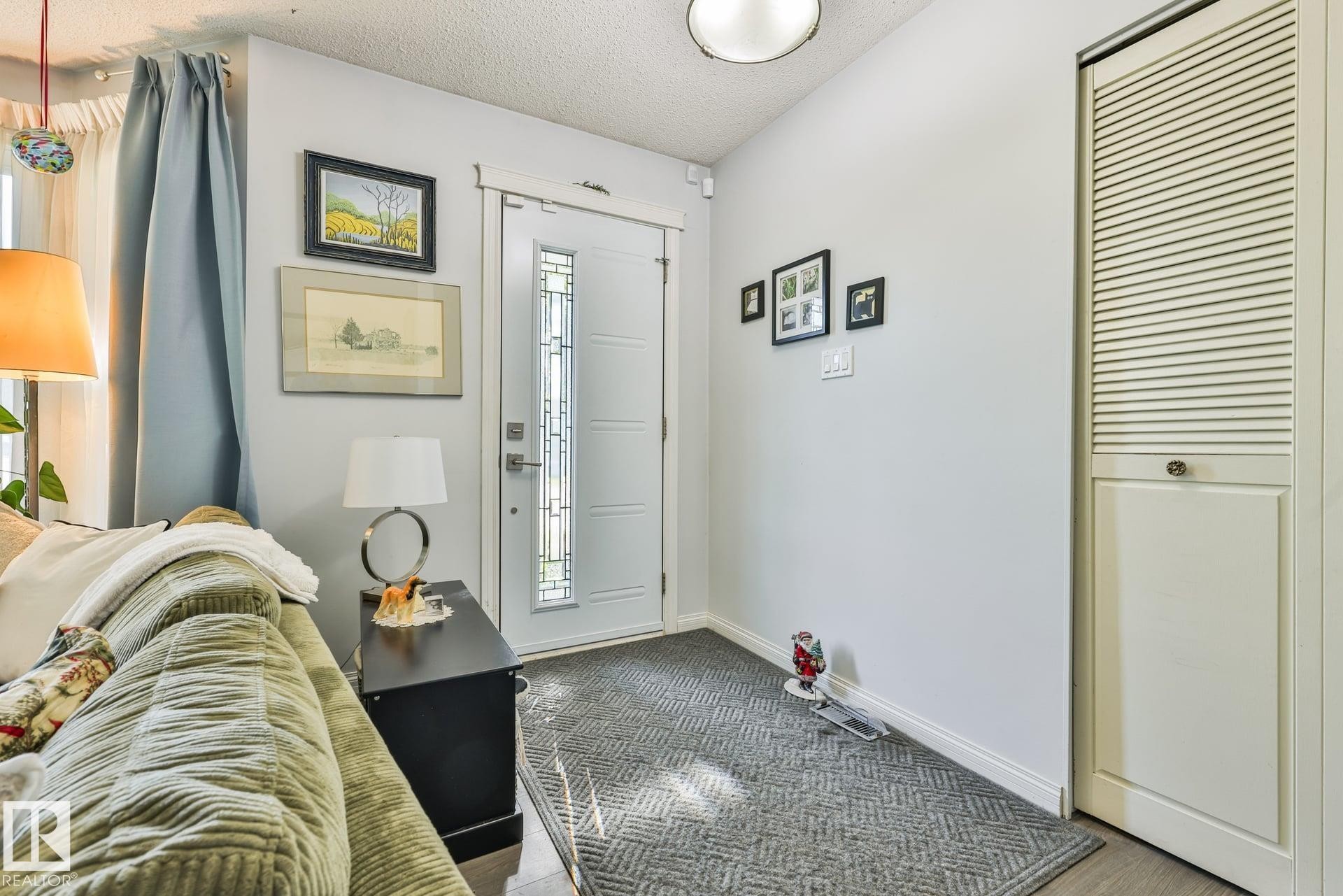 Comfortable bedroom featuring neutral décor, carpeted flooring, and ample natural light from a window with privacy glass - 8932 187 Street Nw, Edmonton, AB - Indoor