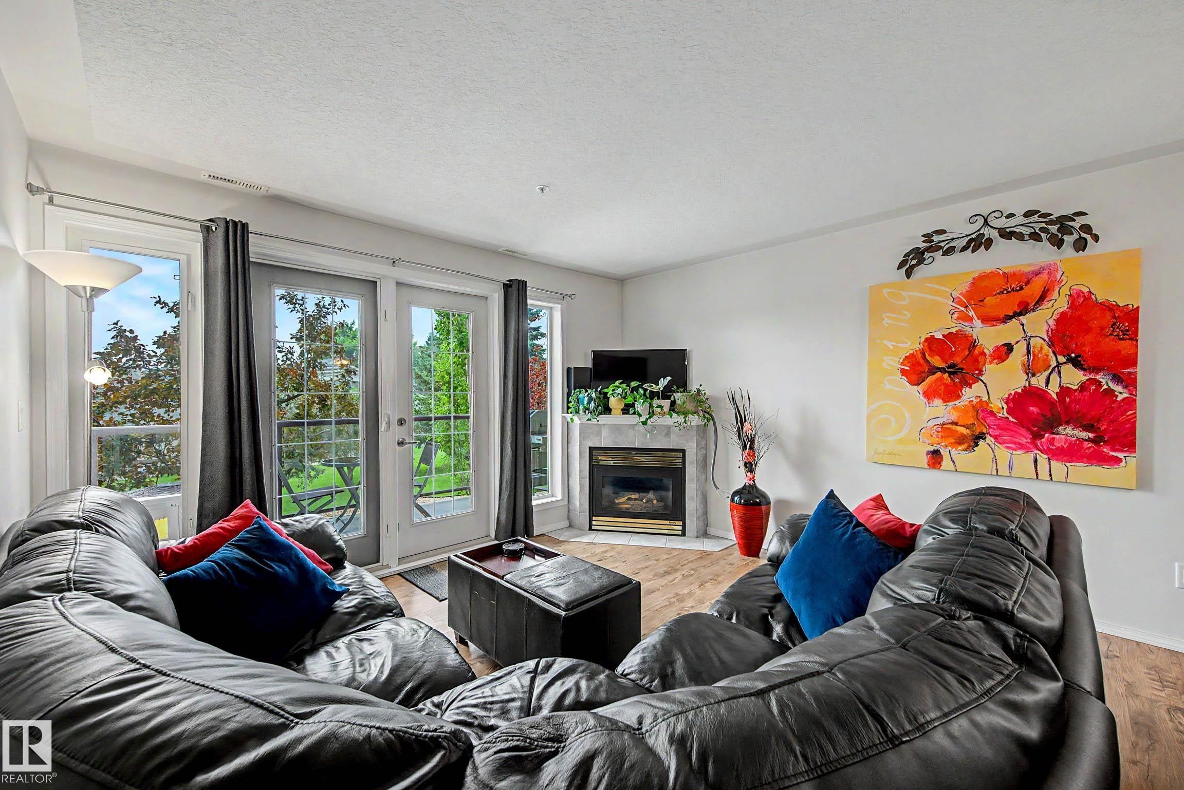#209 237 Youville Dr E Nw, Edmonton, AB - Indoor Photo Showing Living Room With Fireplace
