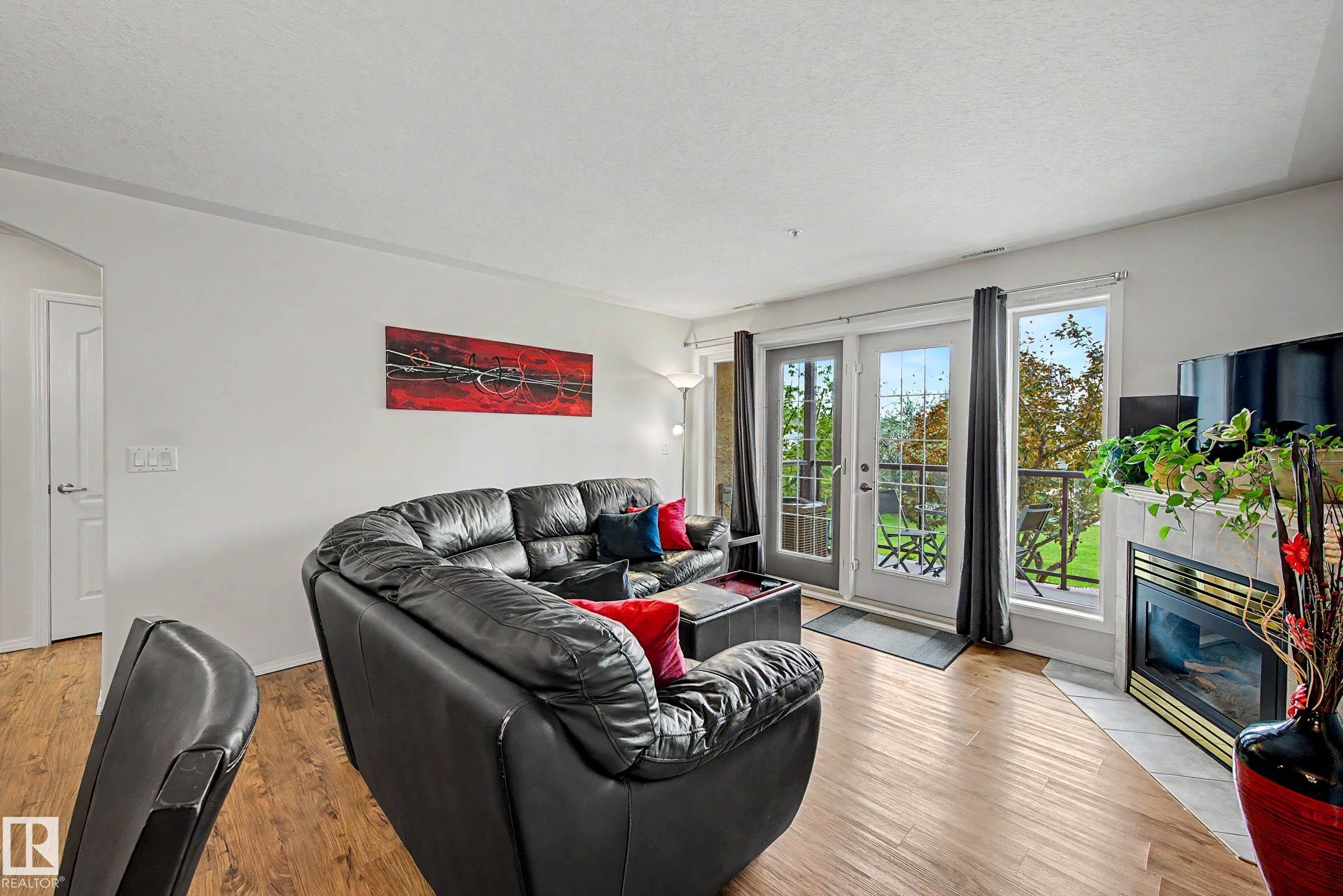#209 237 Youville Dr E Nw, Edmonton, AB - Indoor Photo Showing Living Room With Fireplace