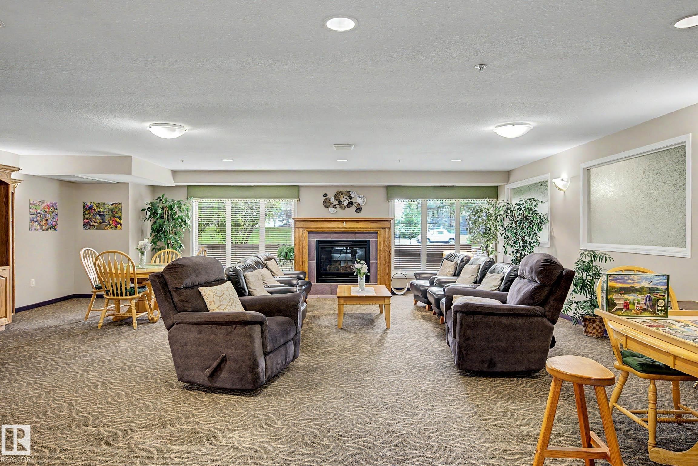 #209 237 Youville Dr E Nw, Edmonton, AB - Indoor Photo Showing Living Room With Fireplace