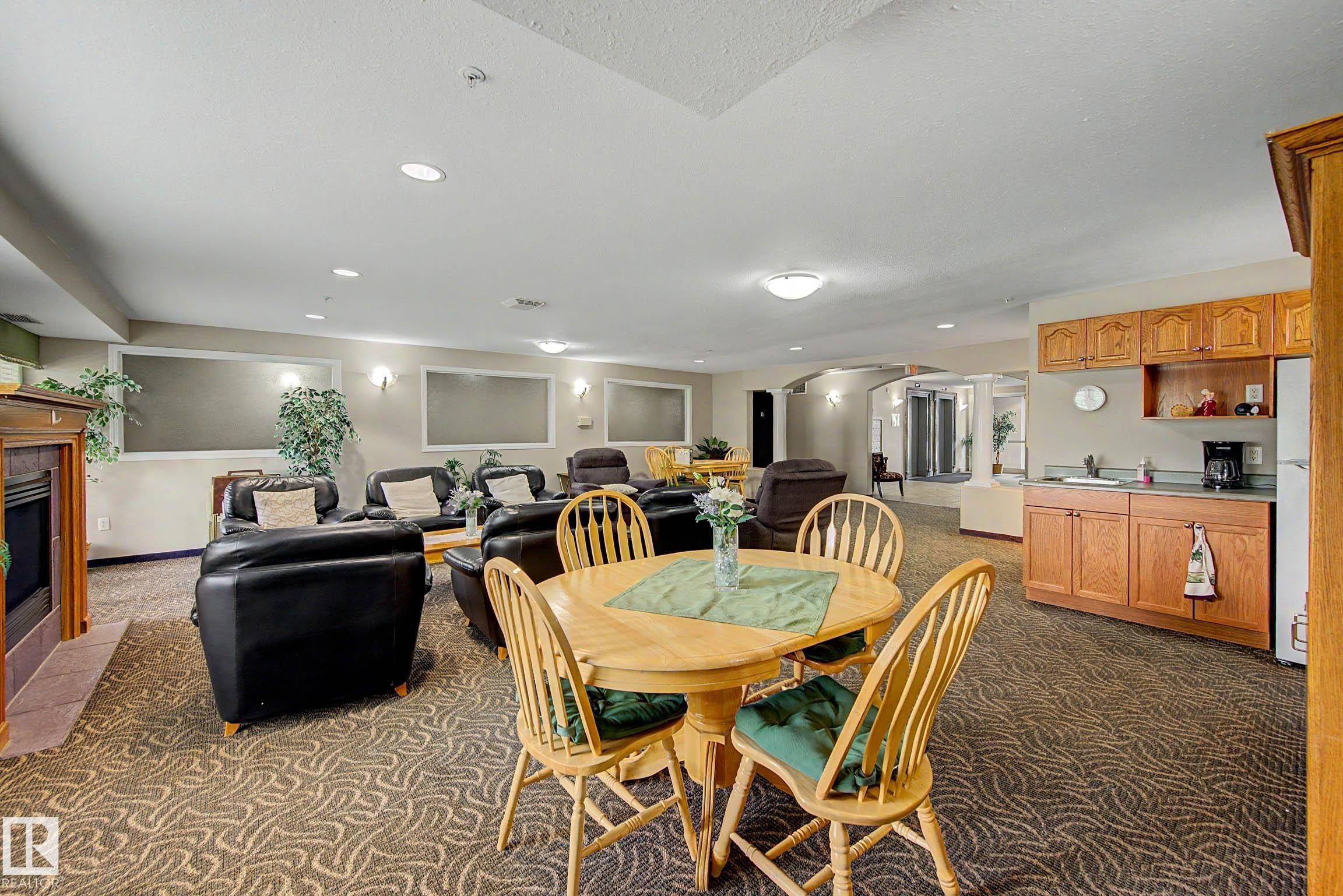 #209 237 Youville Dr E Nw, Edmonton, AB - Indoor Photo Showing Dining Room With Fireplace