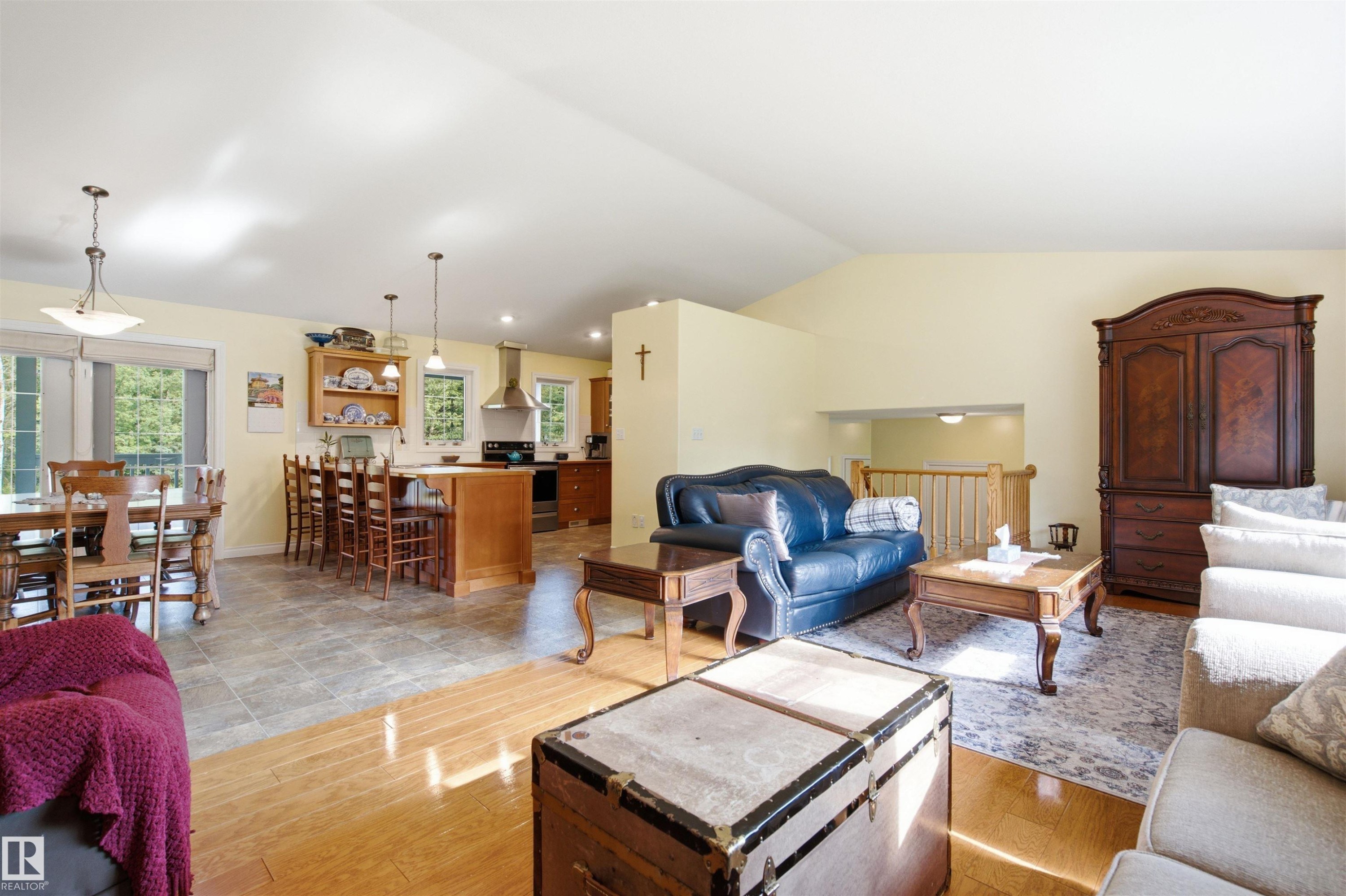 Spacious open-concept living area featuring vaulted ceilings, wood-finish flooring, and ample natural light - 59125 Range Road 102, Rural St. Paul County, AB - Indoor Photo Showing Living Room