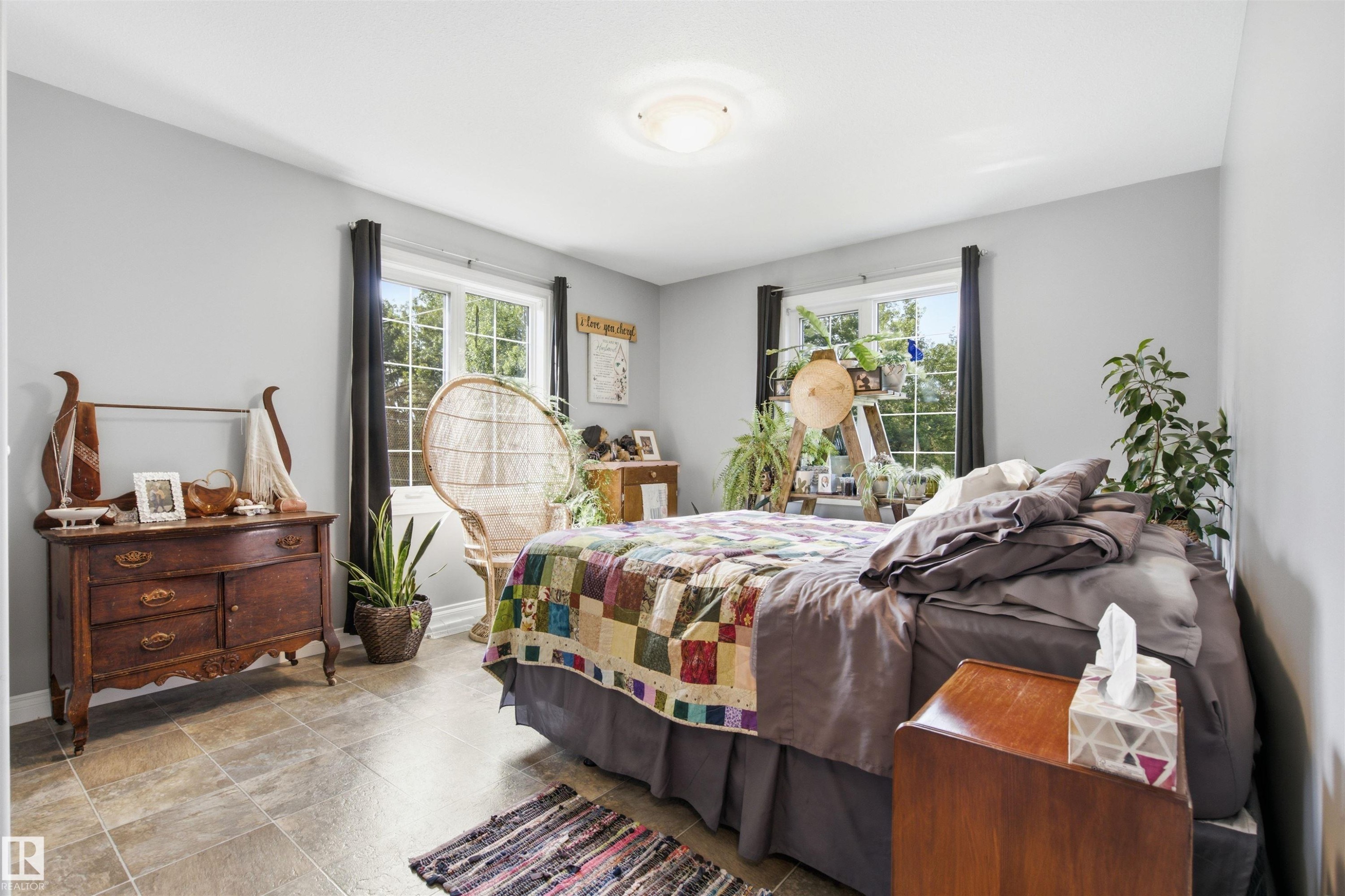 Spacious primary bedroom featuring light gray walls, and two large windows - 59125 Range Road 102, Rural St. Paul County, AB - Indoor Photo Showing Bedroom