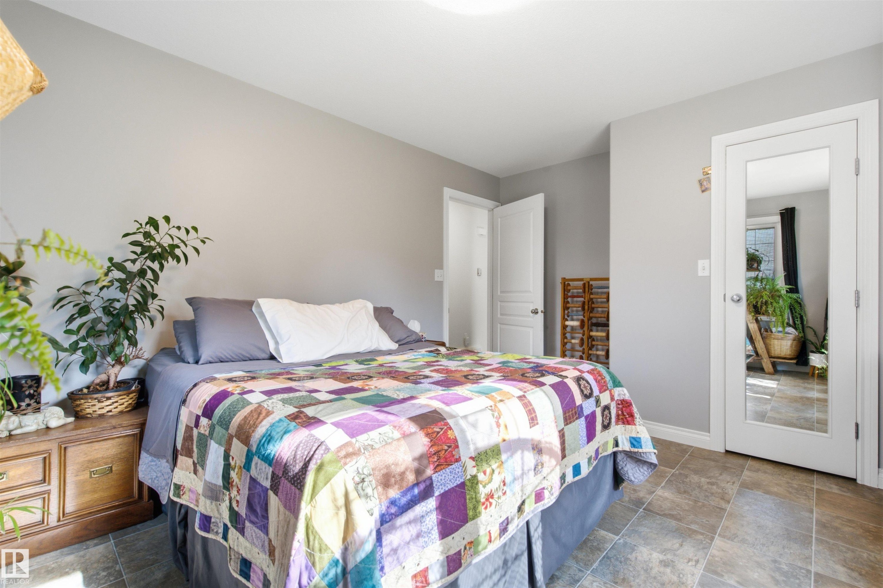 Spacious primary bedroom featuring light grey walls and a walk in closet - 59125 Range Road 102, Rural St. Paul County, AB - Indoor Photo Showing Bedroom