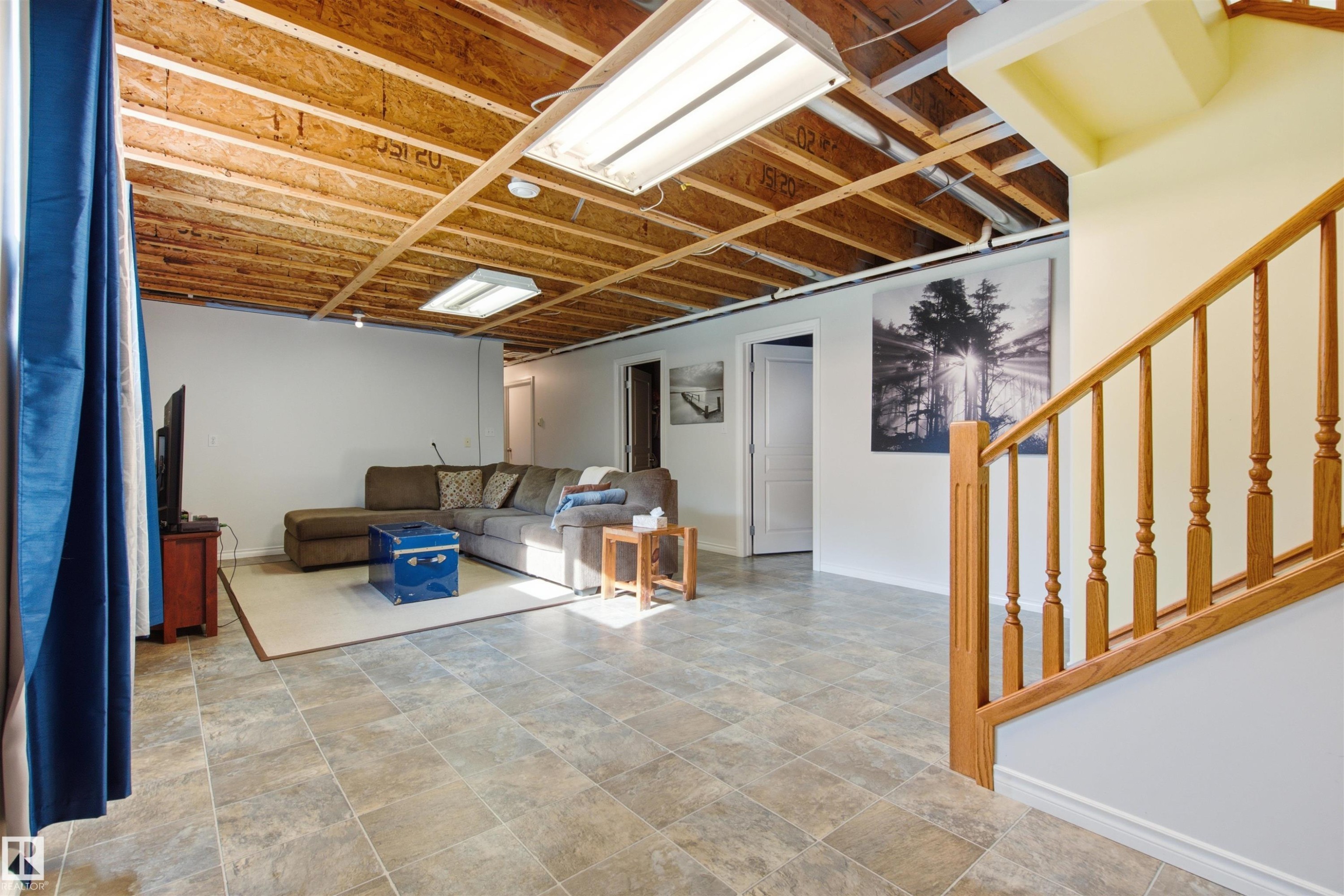 Spacious mostly finished family room with rough in for wet bar - 59125 Range Road 102, Rural St. Paul County, AB - Indoor Photo Showing Other Room