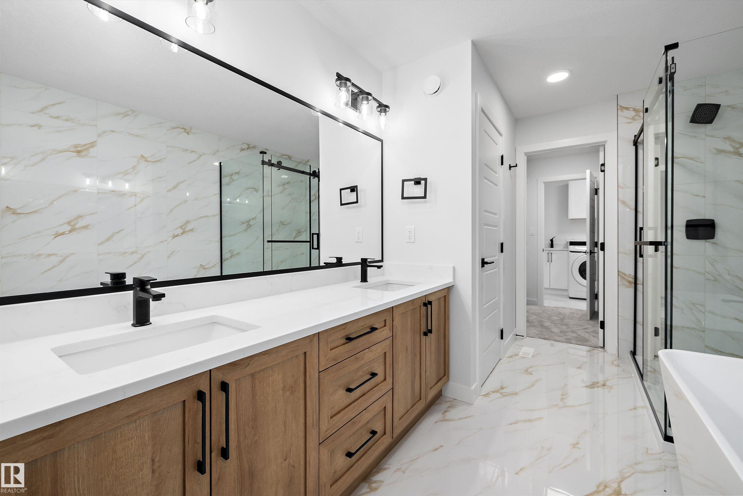 Dual vanity with wood-finish cabinetry and white countertops - 971 Elderberry Landing Nw, Edmonton, AB - Indoor Photo Showing Bathroom