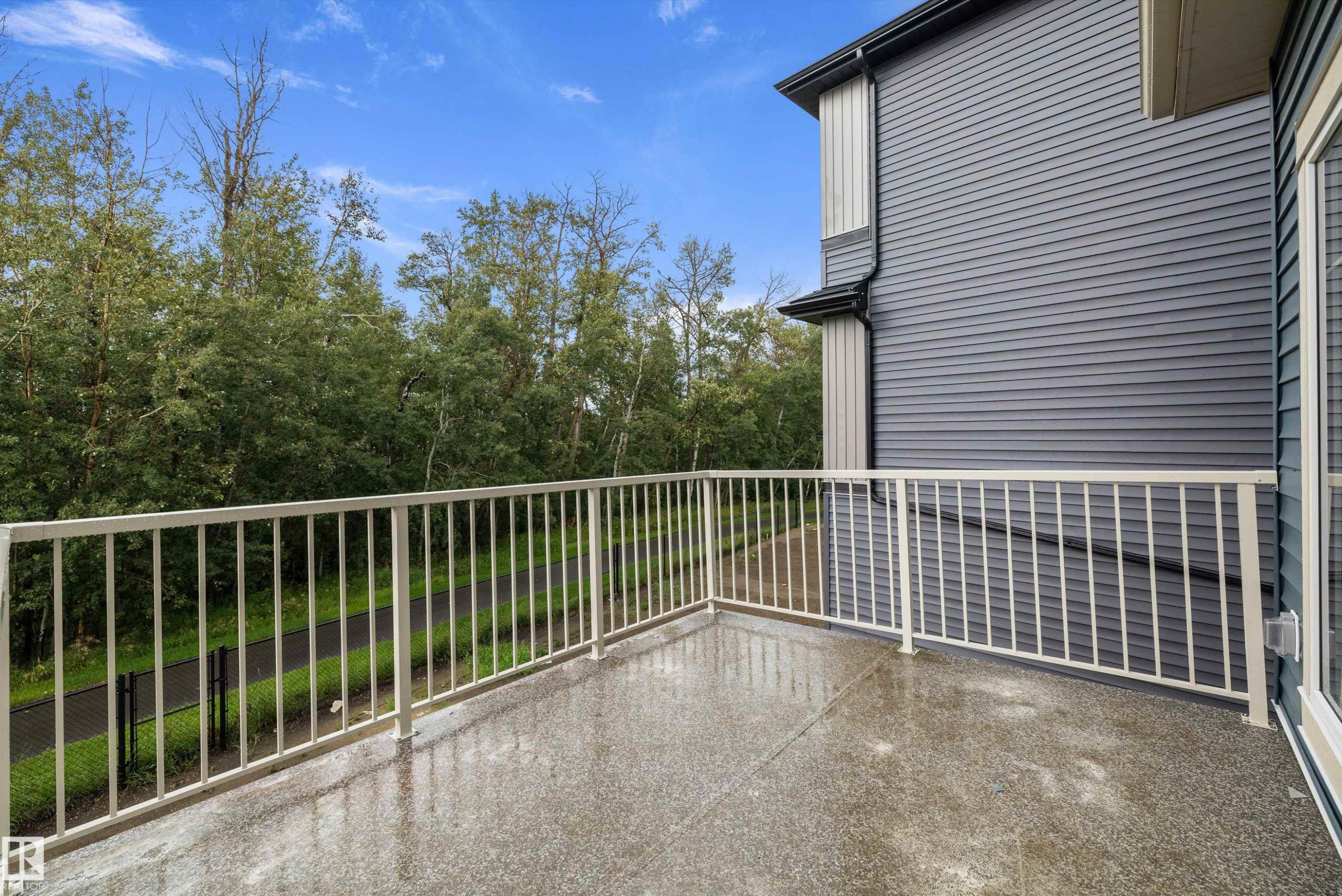 Private balcony with a textured surface, white metal railing, and a durable siding exterior - 971 Elderberry Landing Nw, Edmonton, AB - Outdoor With Exterior