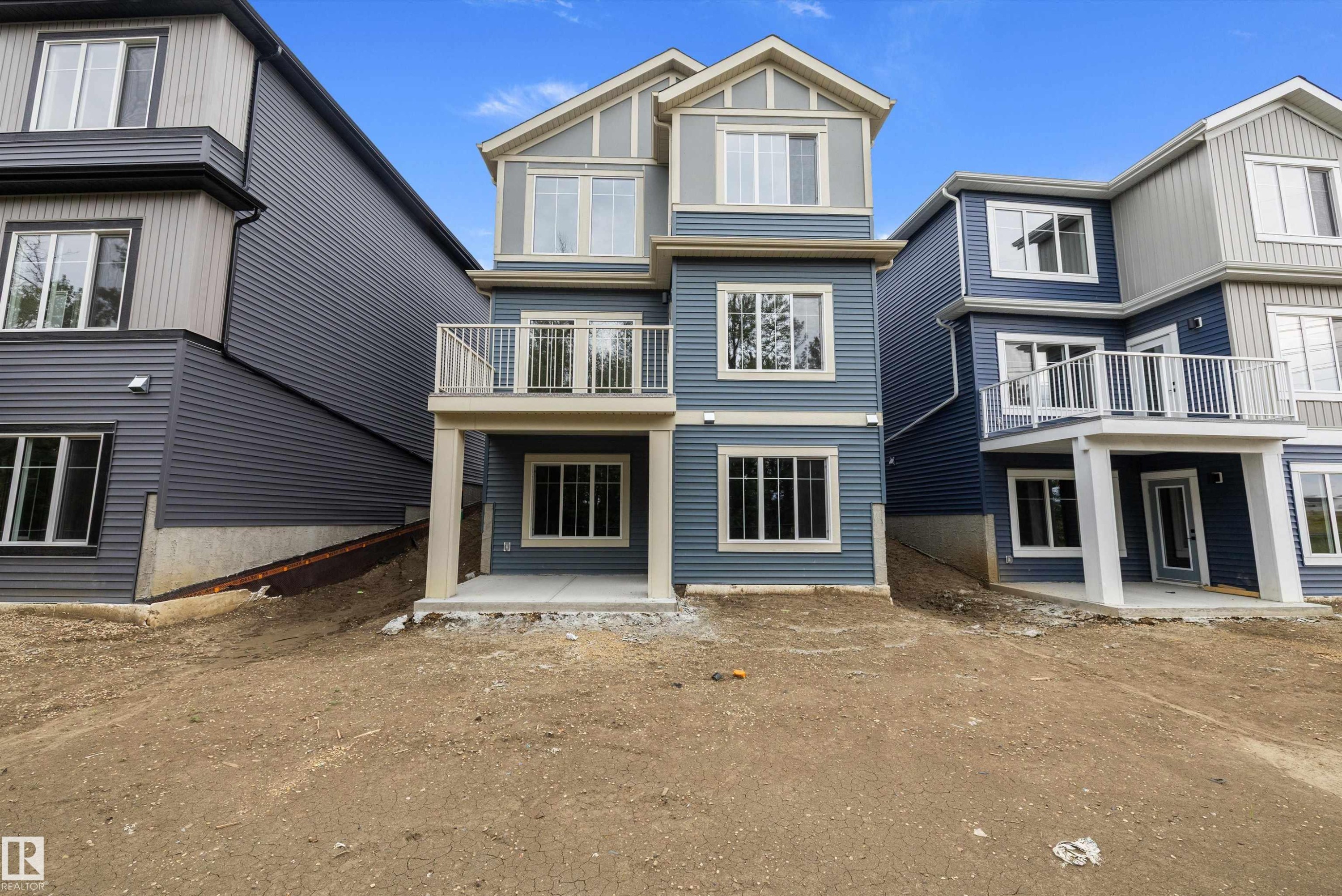 Multi-level exterior with blue siding and contrasting light grey accents - 971 Elderberry Landing Nw, Edmonton, AB - Outdoor With Facade