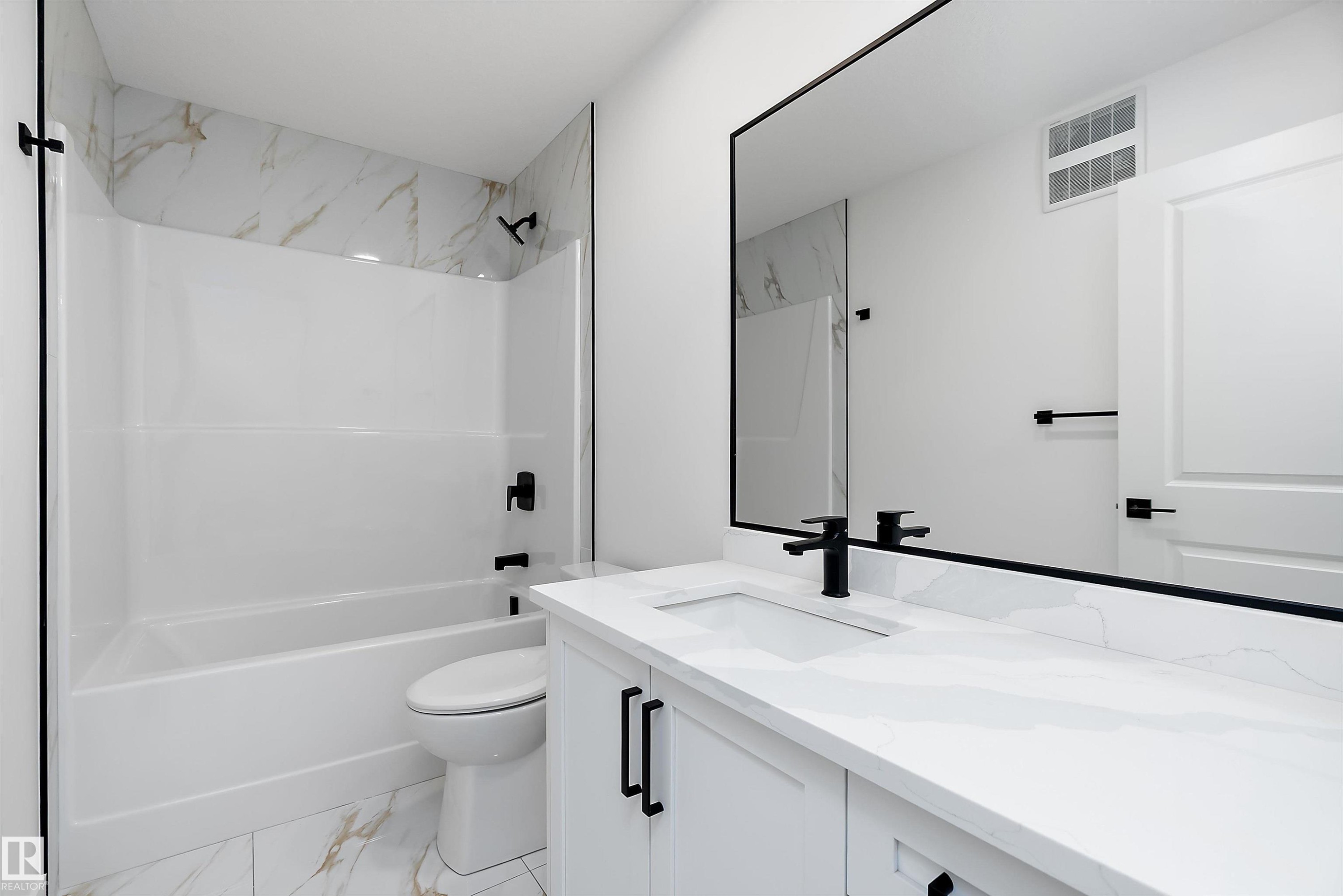 White vanity with an integrated sink, matte black faucet, and matching hardware - 1763 Crossbill Loop Nw, Edmonton, AB - Indoor Photo Showing Bathroom