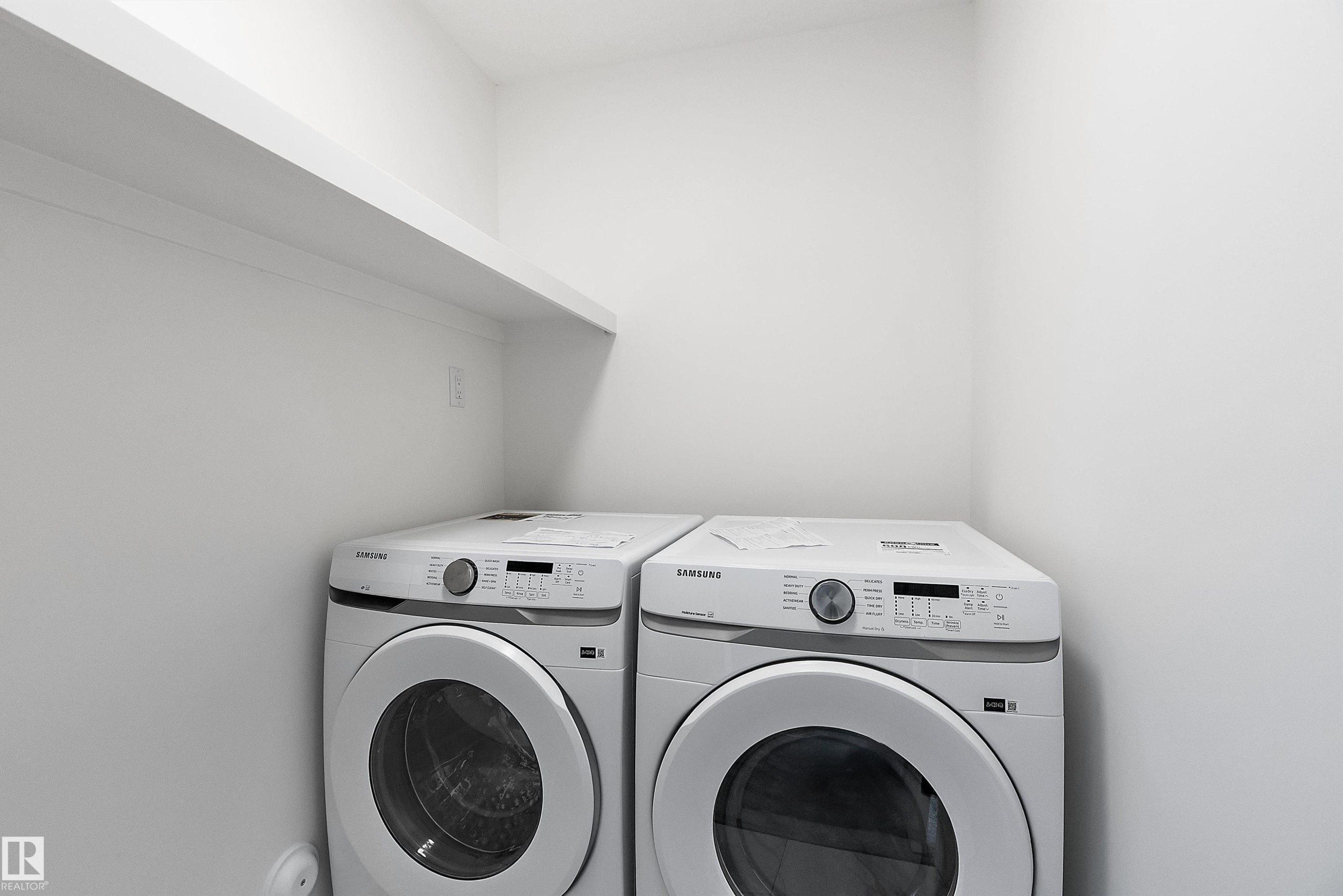Built-in white shelving above appliances - 1763 Crossbill Loop Nw, Edmonton, AB - Indoor Photo Showing Laundry Room