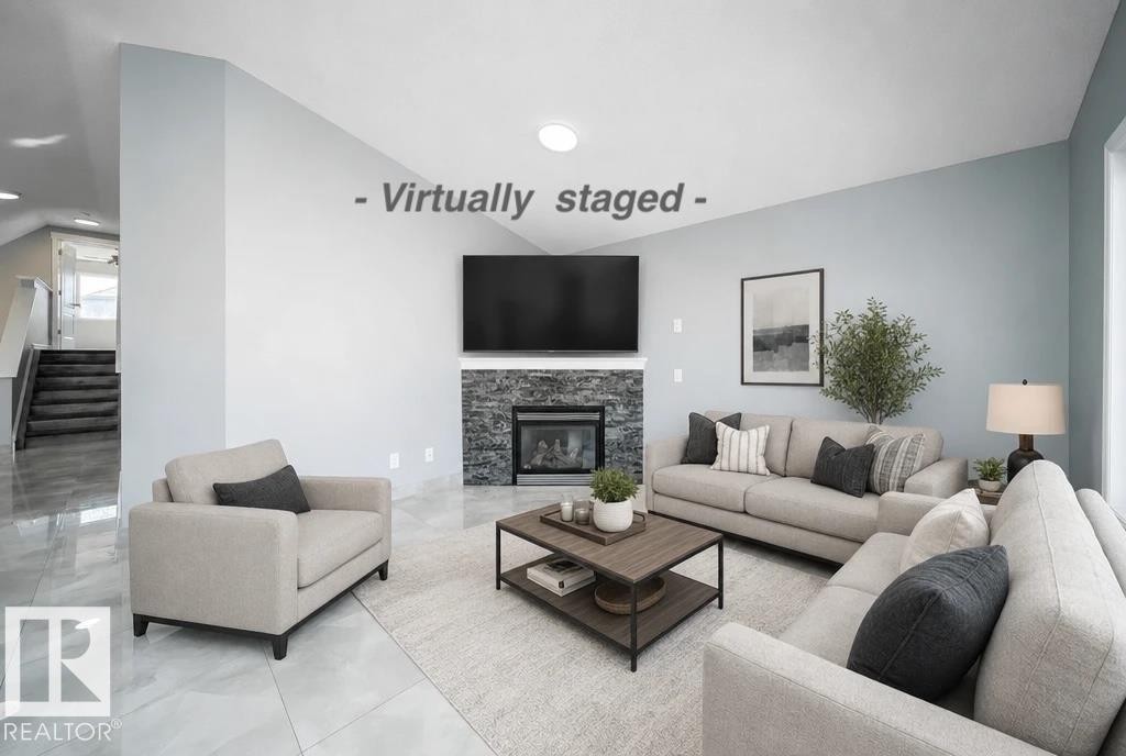Living area featuring a stone-clad fireplace and light-toned walls - 7848 7 Avenue Sw, Edmonton, AB