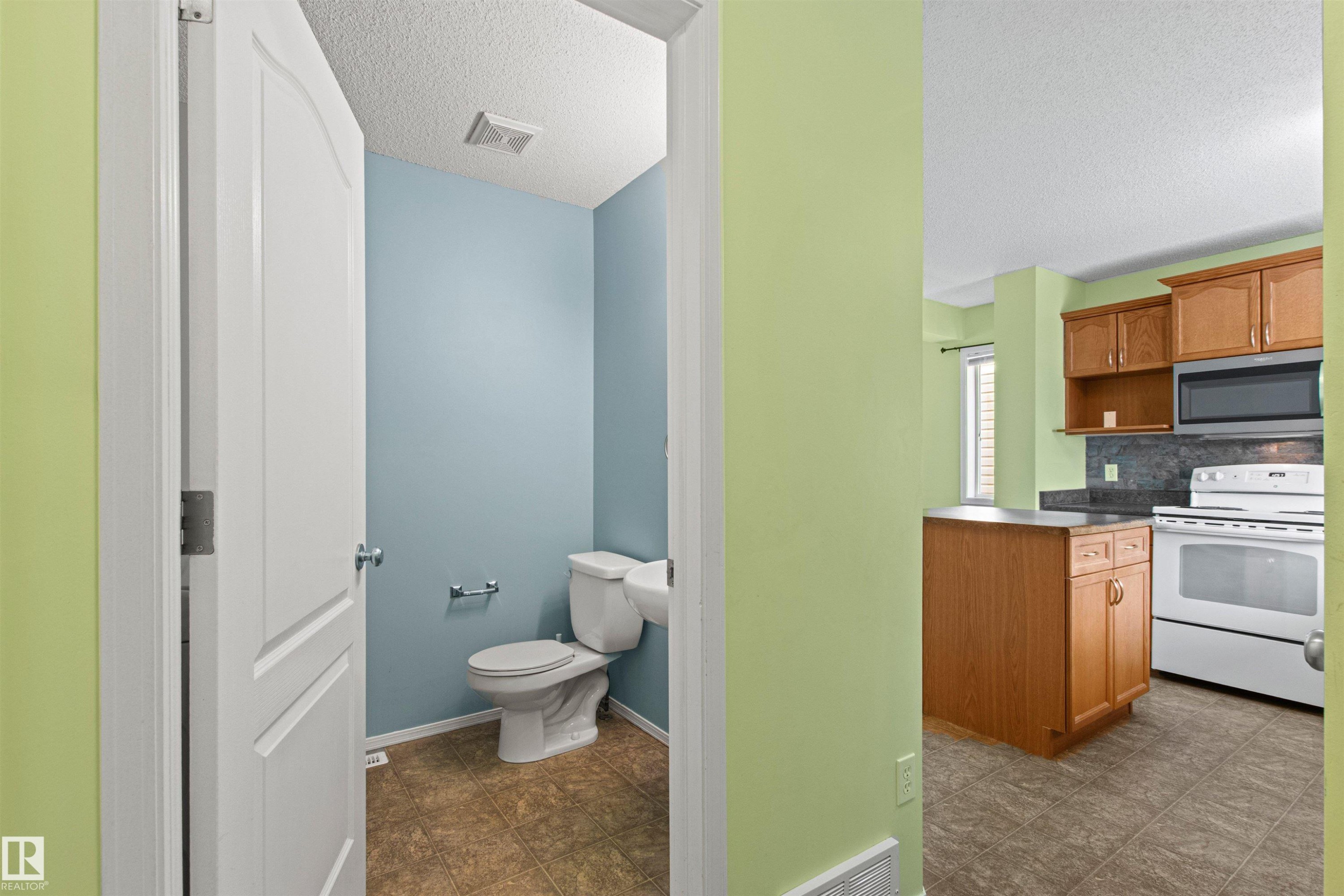 Powder room with tiled flooring - 9118 Scott Crescent Nw, Edmonton, AB - Indoor
