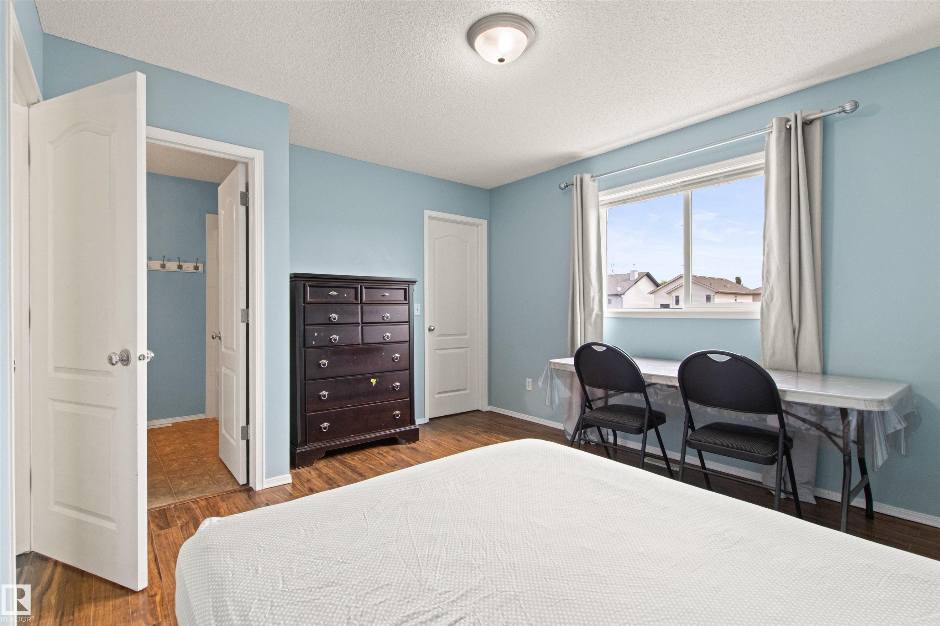 Wood-finish flooring throughout - 9118 Scott Crescent Nw, Edmonton, AB - Indoor Photo Showing Bedroom