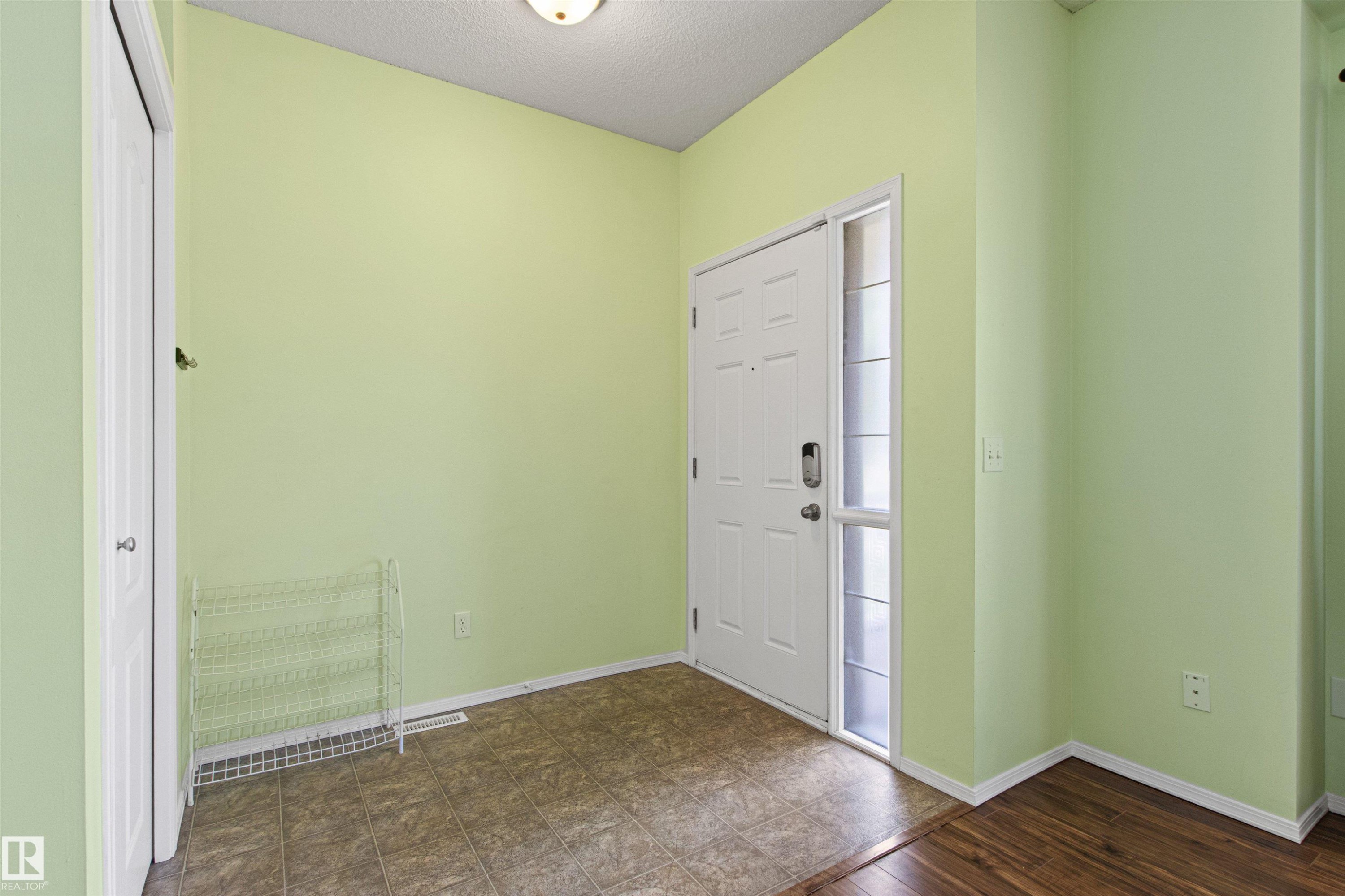 Entryway featuring a white paneled door with a sidelight, tile flooring, and a flush mount ceiling light - 9118 Scott Crescent Nw, Edmonton, AB - Indoor Photo Showing Other Room