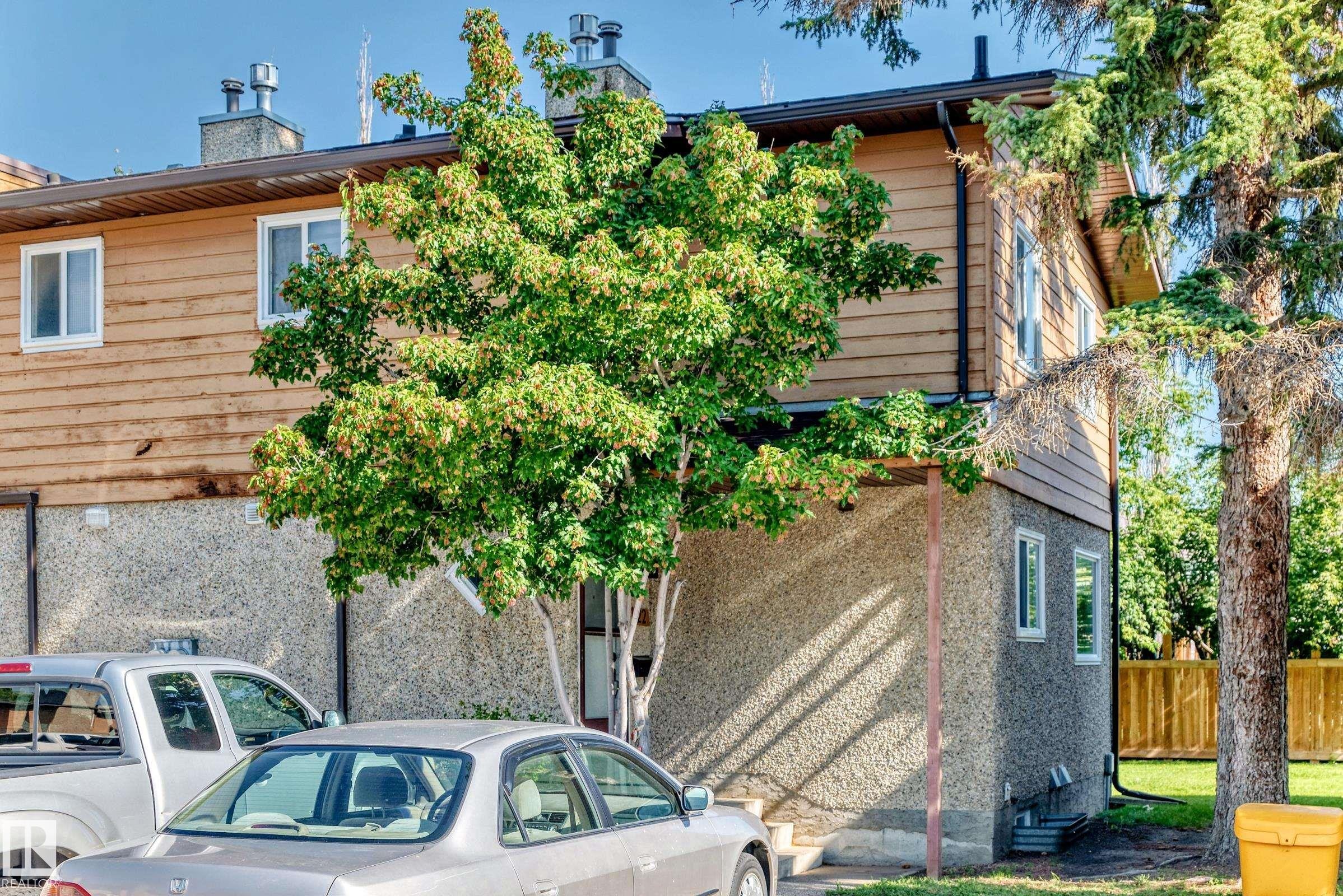 Wood-finish siding with white-framed windows - #22 3812 20 Av Nw, Edmonton, AB - Outdoor With Exterior