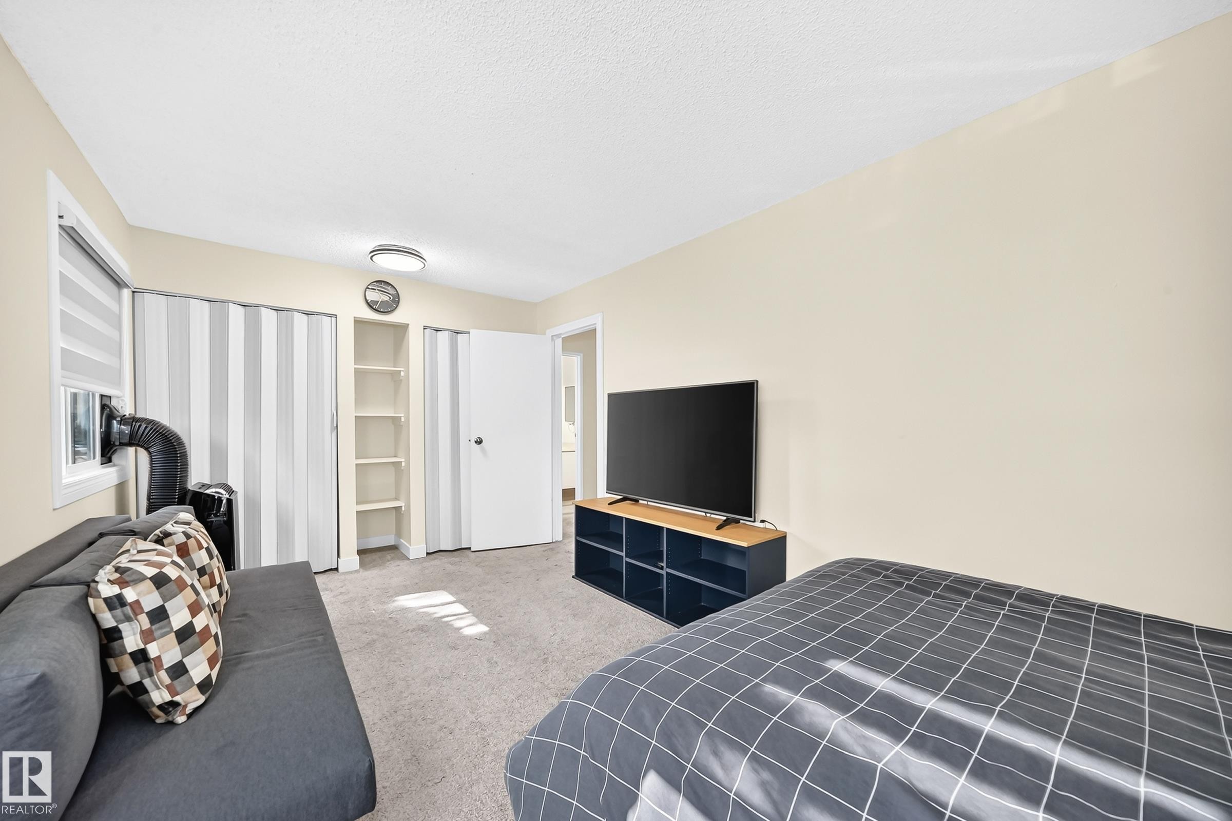 Wall-to-wall carpeting with light-colored walls and a flat ceiling - #22 3812 20 Av Nw, Edmonton, AB - Indoor Photo Showing Bedroom