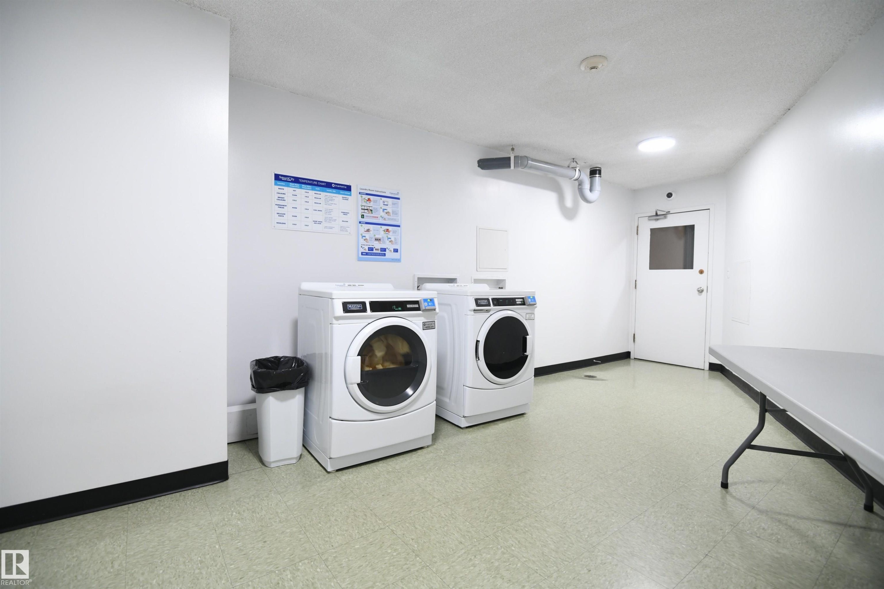 Each floor in the building is equipped with a large, bright laundry room. Convenient trash chutes, and multiple elevators provide maximum convenience - #1305 13910 Stony Plain Rd Nw, Edmonton, AB - Indoor Photo Showing Laundry Room