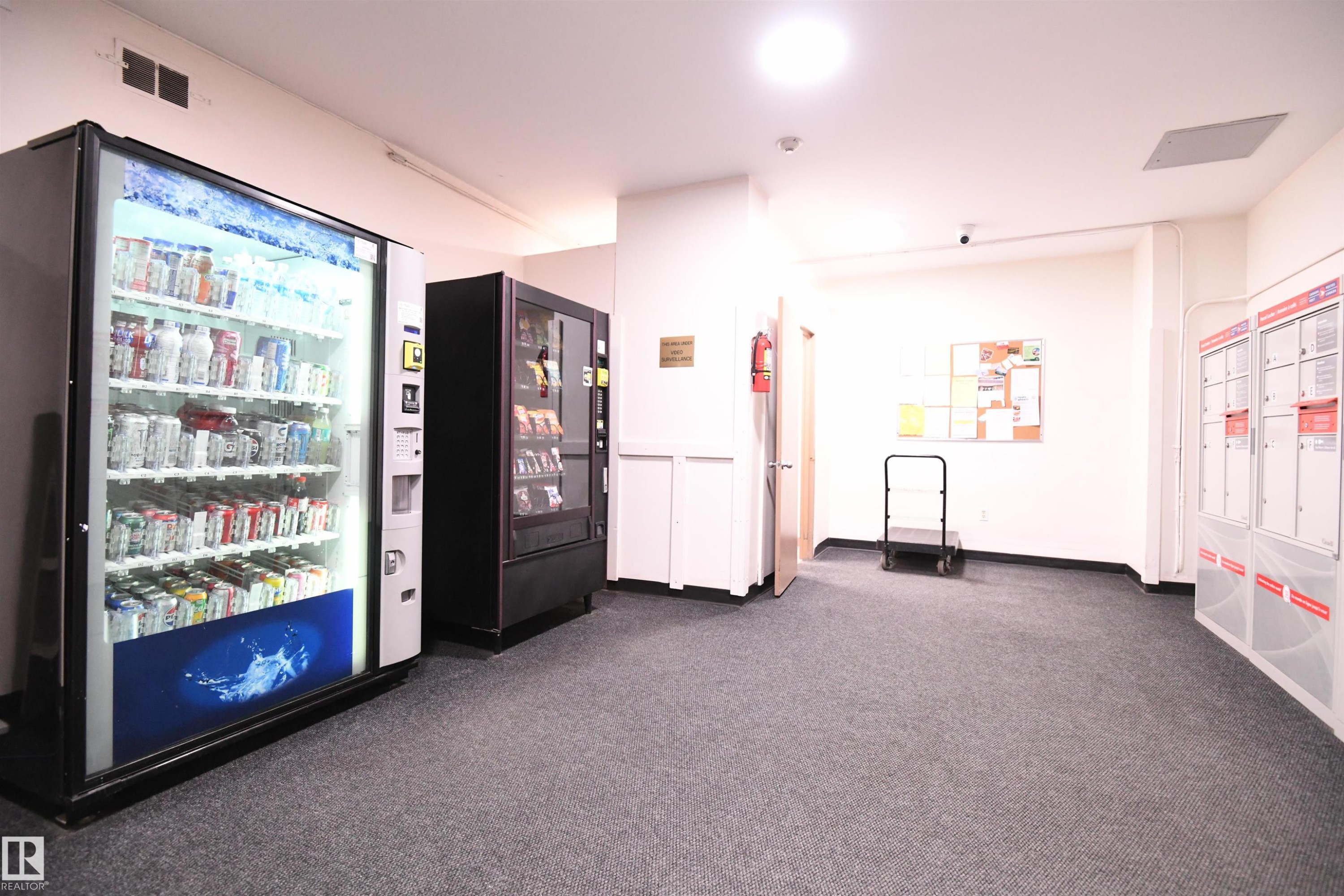 Similar to what you may find in some boutique hotels, vending machines have even been installed for the convenience of the residents - #1305 13910 Stony Plain Rd Nw, Edmonton, AB - Indoor Photo Showing Other Room