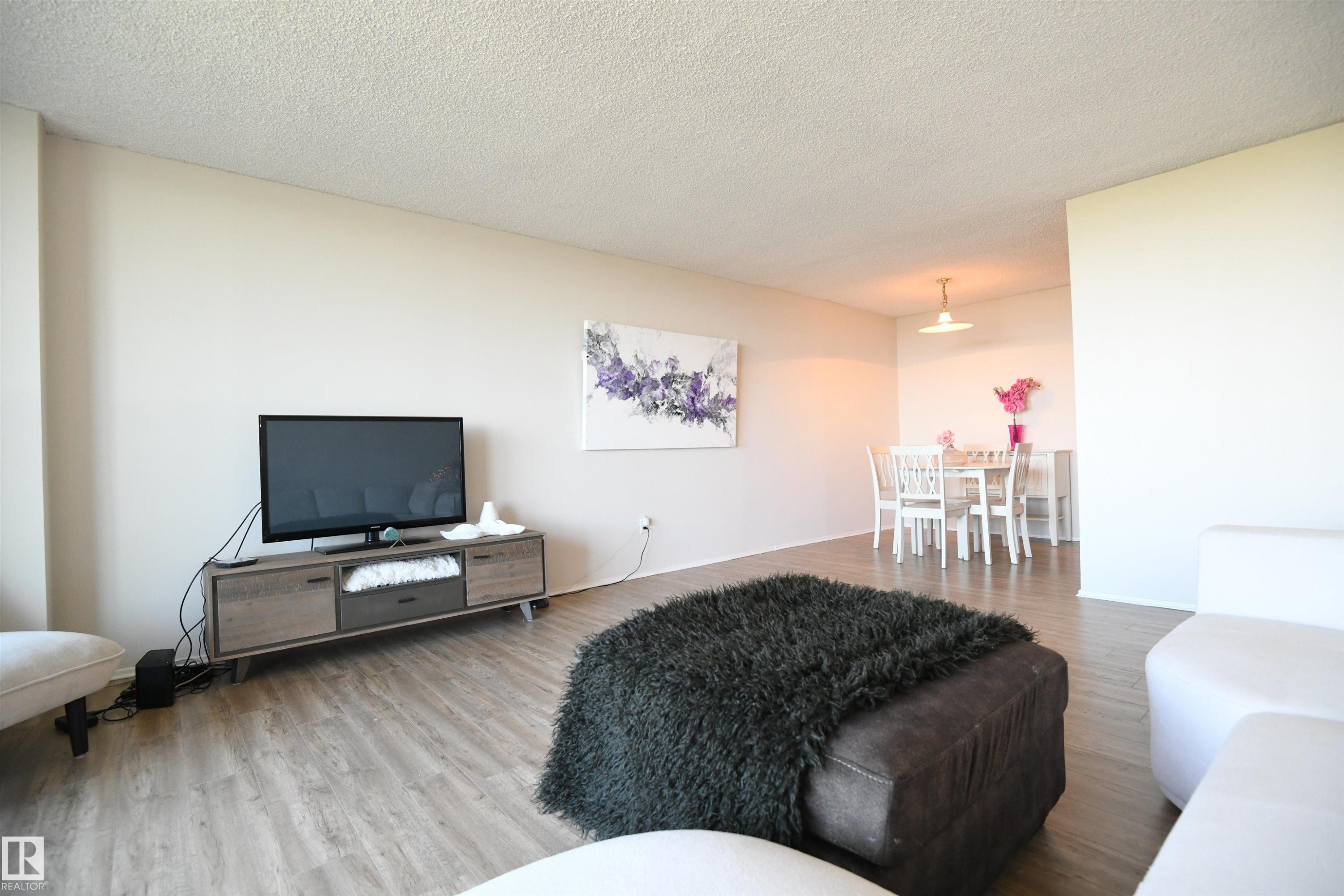 The natural light here, coupled with the view of the city, are intoxicating - #1305 13910 Stony Plain Rd Nw, Edmonton, AB - Indoor Photo Showing Living Room