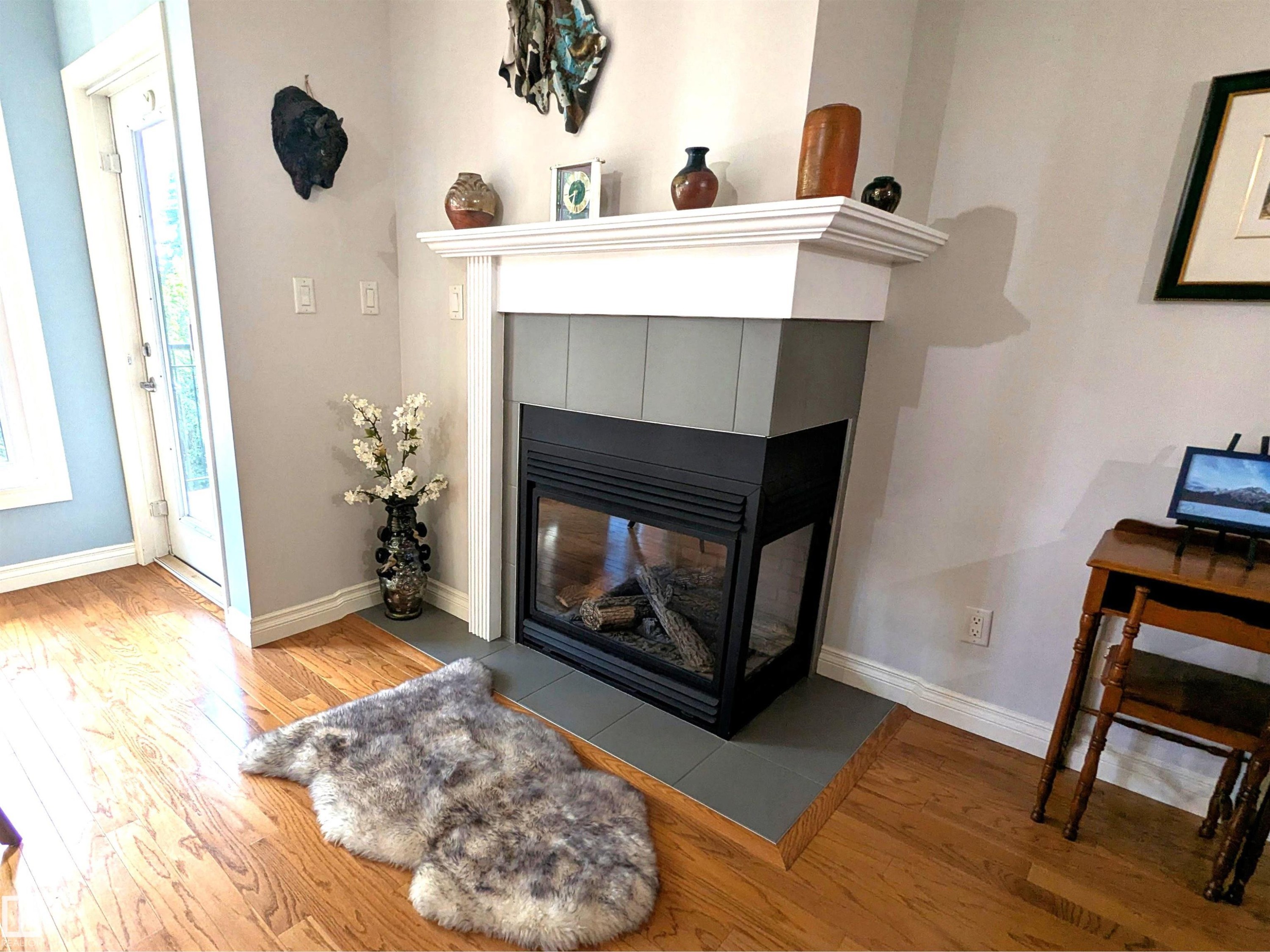 Enjoy the gas fireplace on chilly nights! - #302 9811 96A St Nw, Edmonton, AB - Indoor Photo Showing Living Room With Fireplace