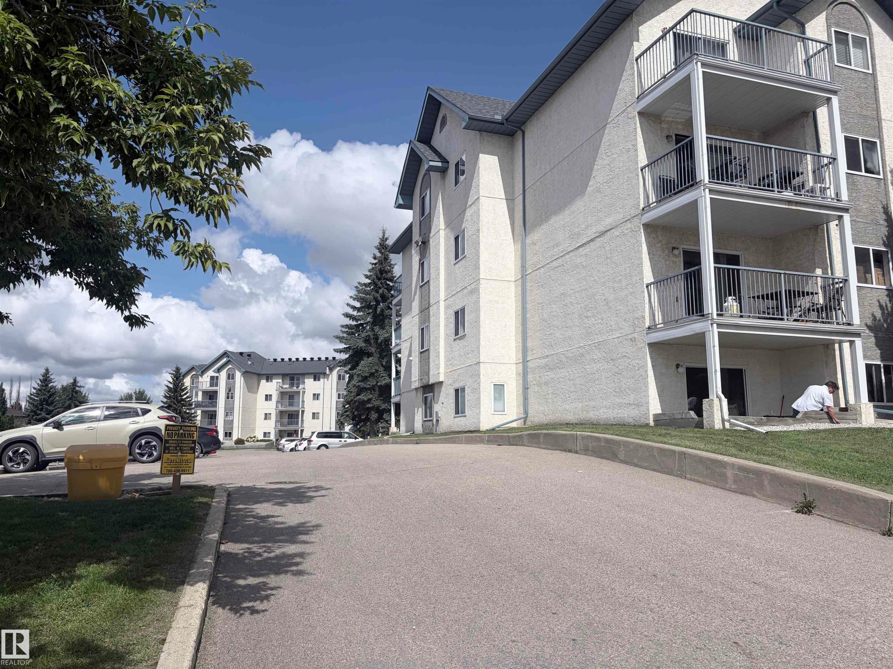 Multi-level building with individual balconies featuring metal railings - #208 6710 158 Av Nw, Edmonton, AB - Outdoor With Balcony